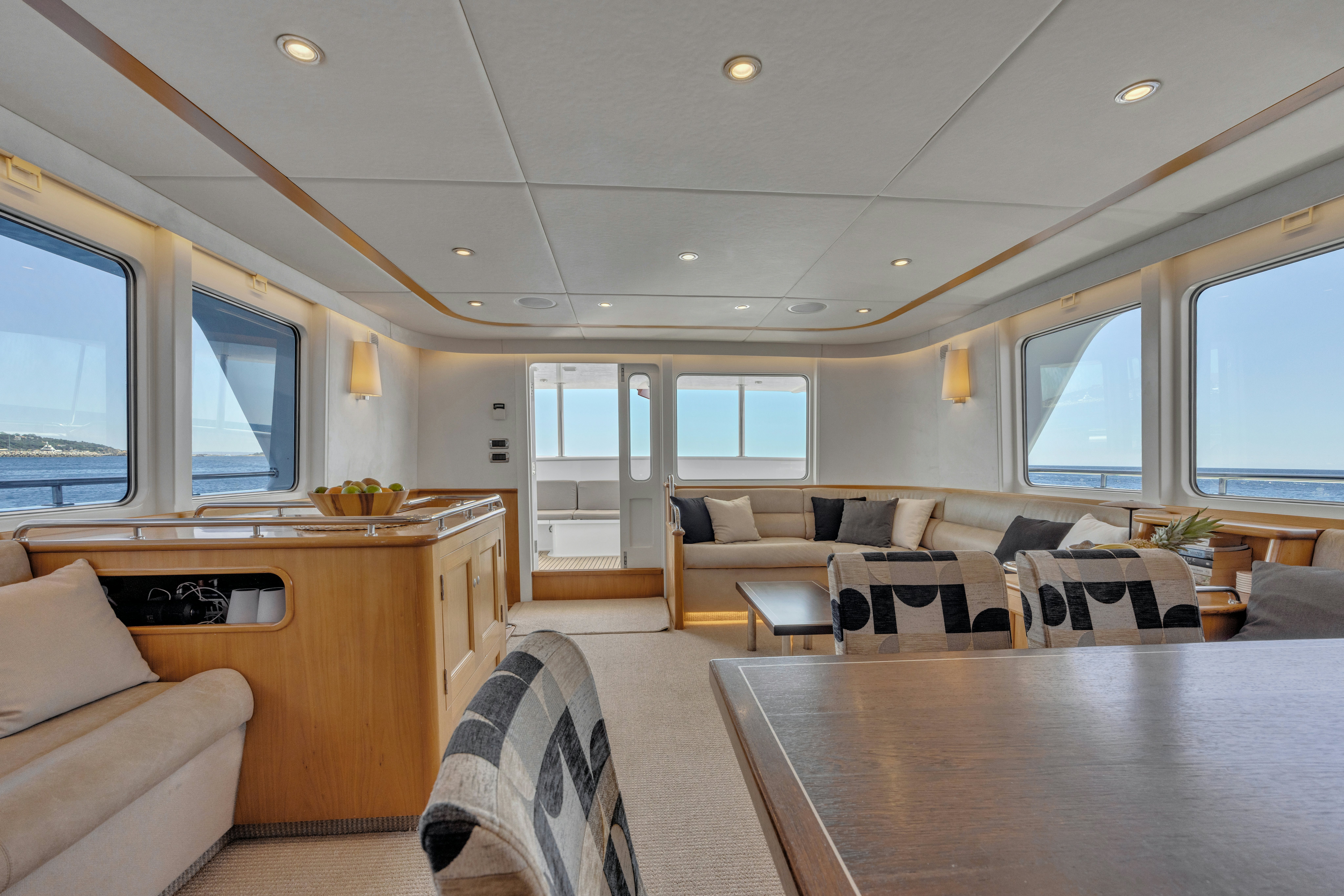 a living room with a table and couches aboard TASMAN Yacht for Sale