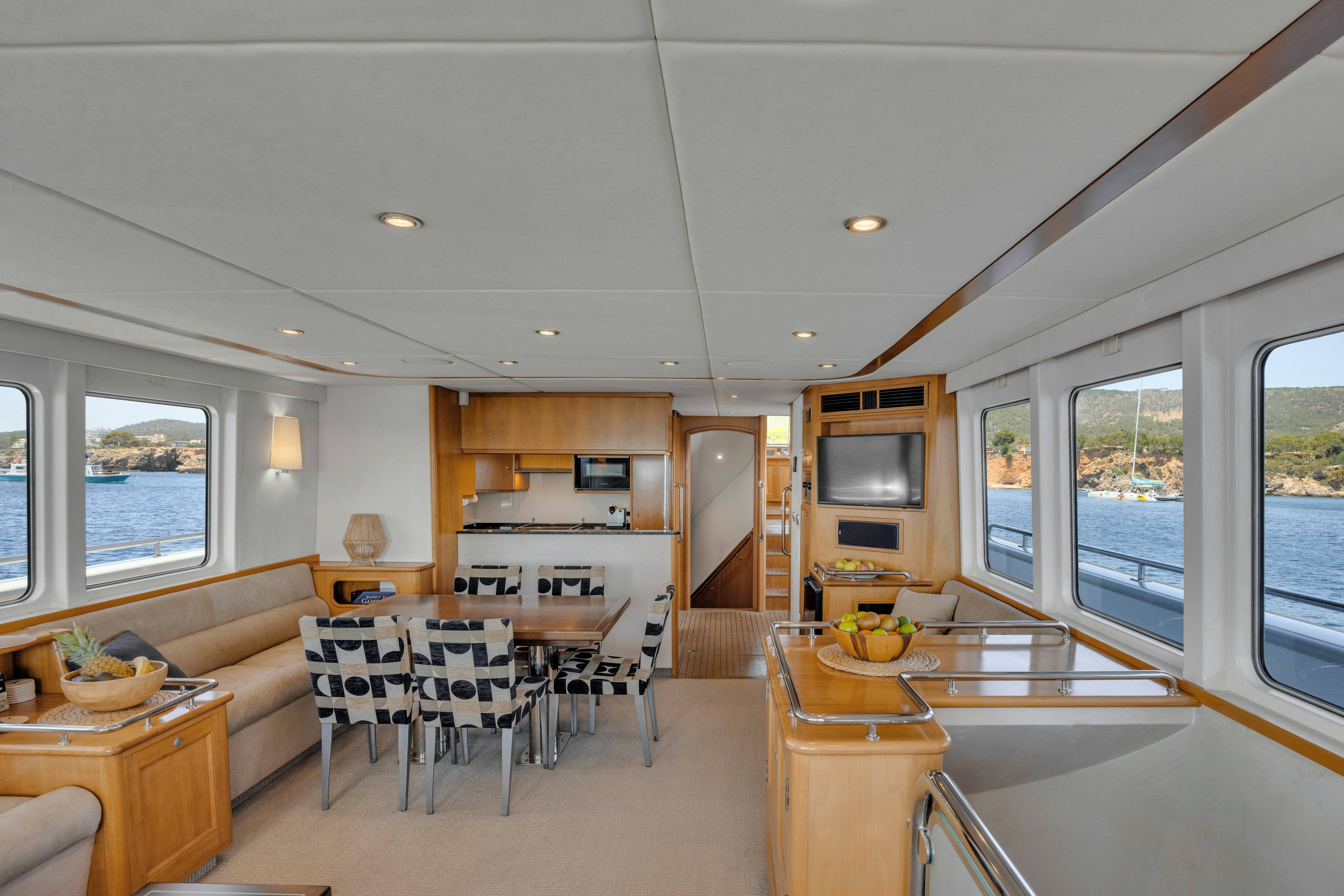 a living room with a kitchen and dining area aboard TASMAN Yacht for Sale