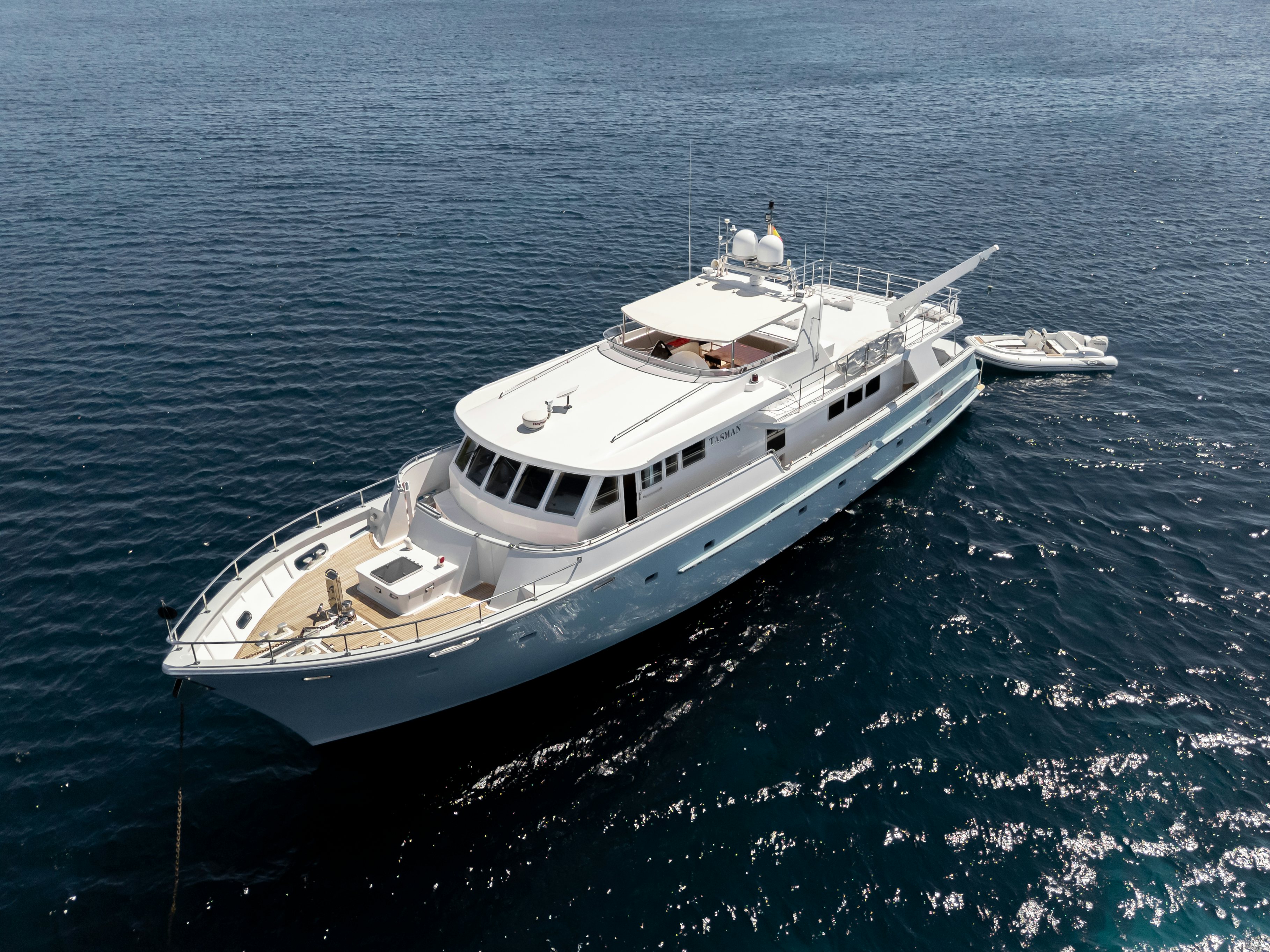 a white yacht in the water aboard TASMAN Yacht for Sale