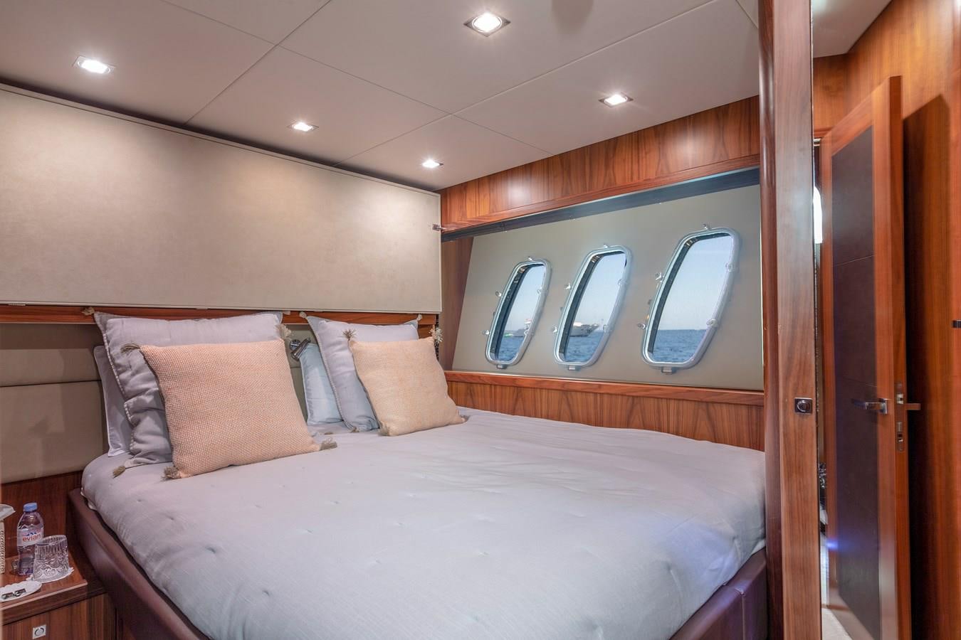 a bed with a white comforter aboard MR SEA Yacht for Sale