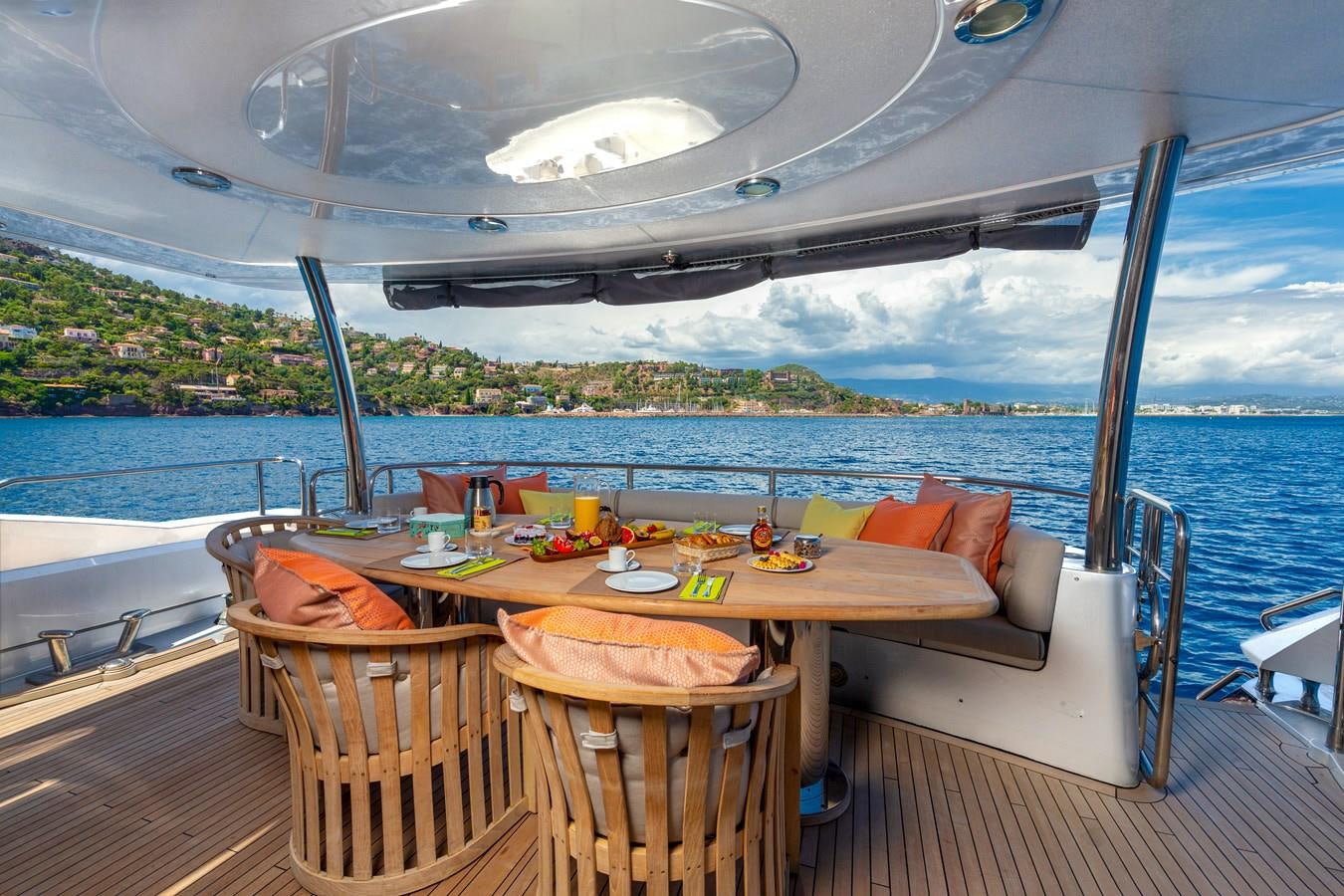 a table on a deck overlooking the ocean aboard MR SEA Yacht for Sale