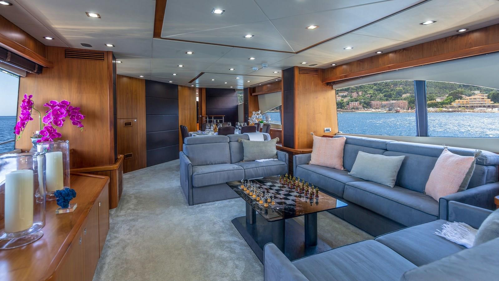 a living room with a couch and a table aboard MR SEA Yacht for Sale