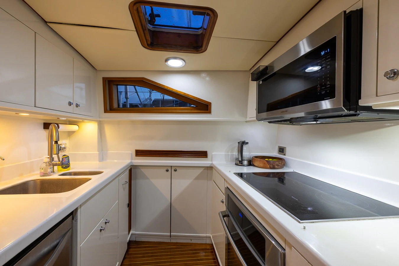 a kitchen with white cabinets aboard ALTAIR Yacht for Sale