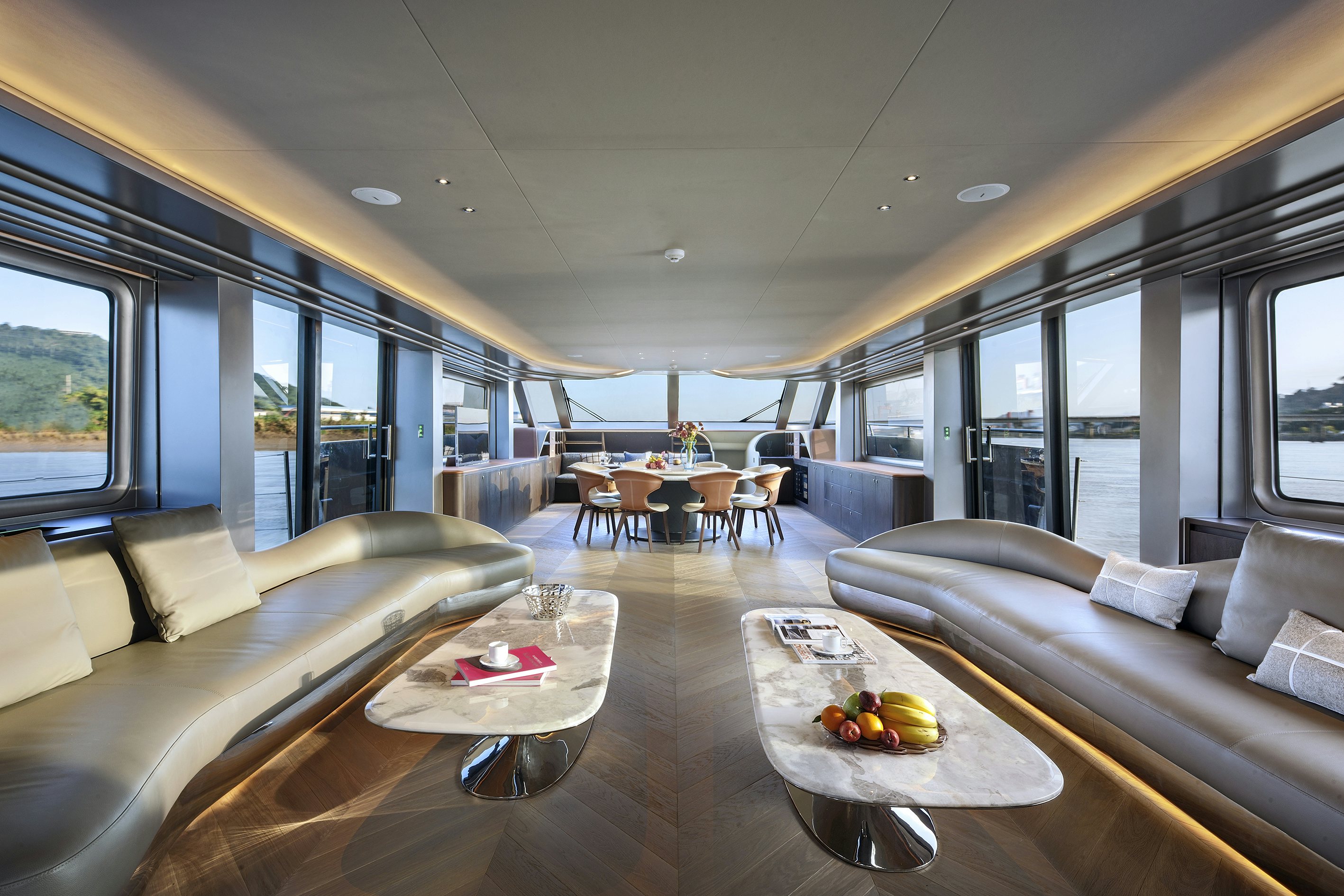 a room with a couch and a table and chairs aboard ALLEGRO FLYBRIDGE 98 Yacht for Sale