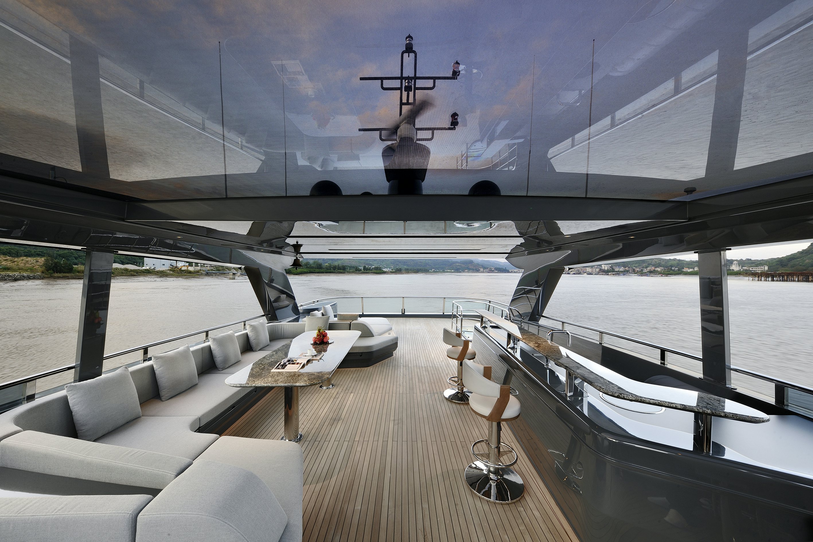 a room with a table and chairs and a large body of water aboard ALLEGRO FLYBRIDGE 98 Yacht for Sale