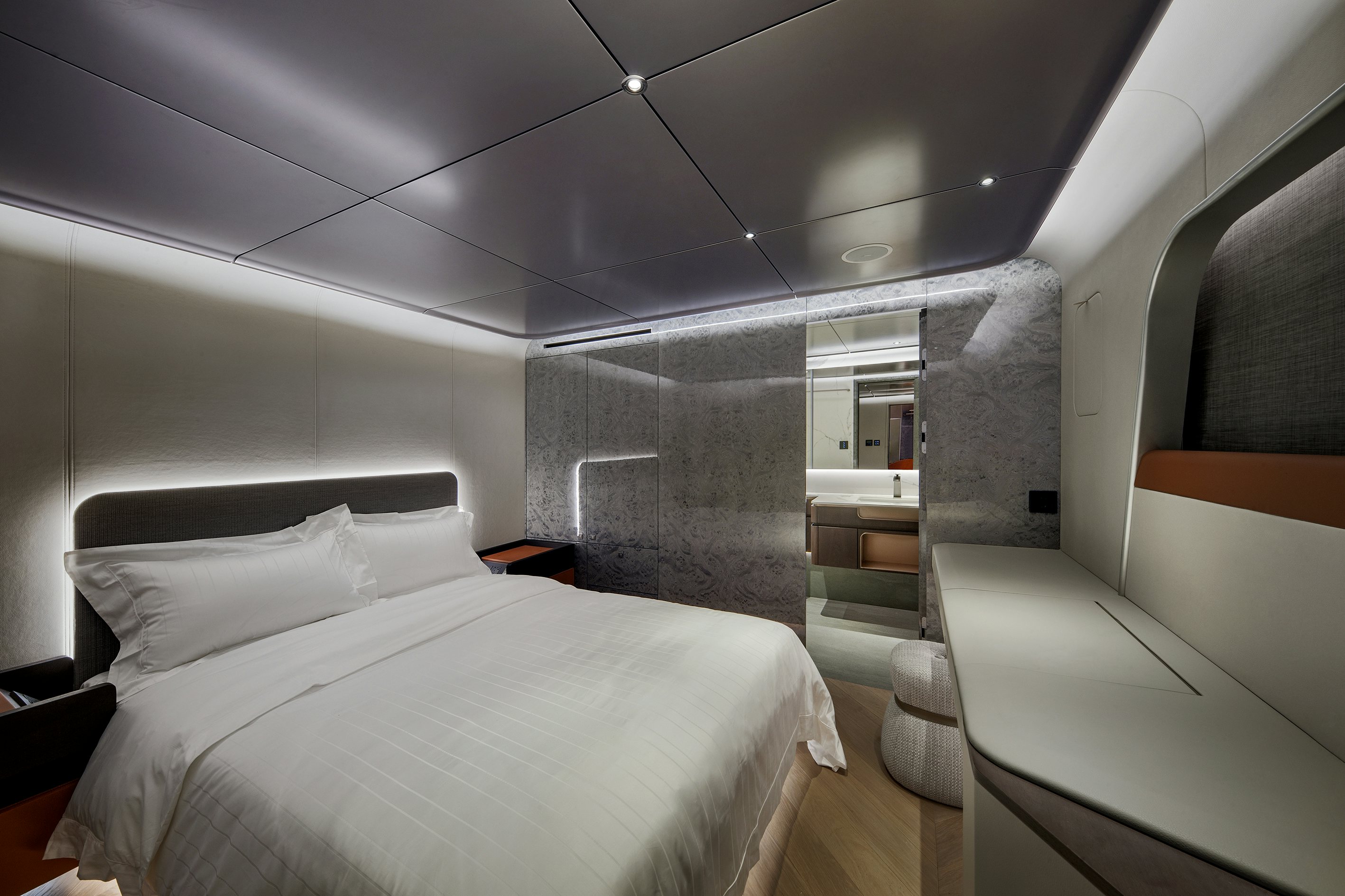 a room with a bed and a chair aboard ALLEGRO FLYBRIDGE 98 Yacht for Sale