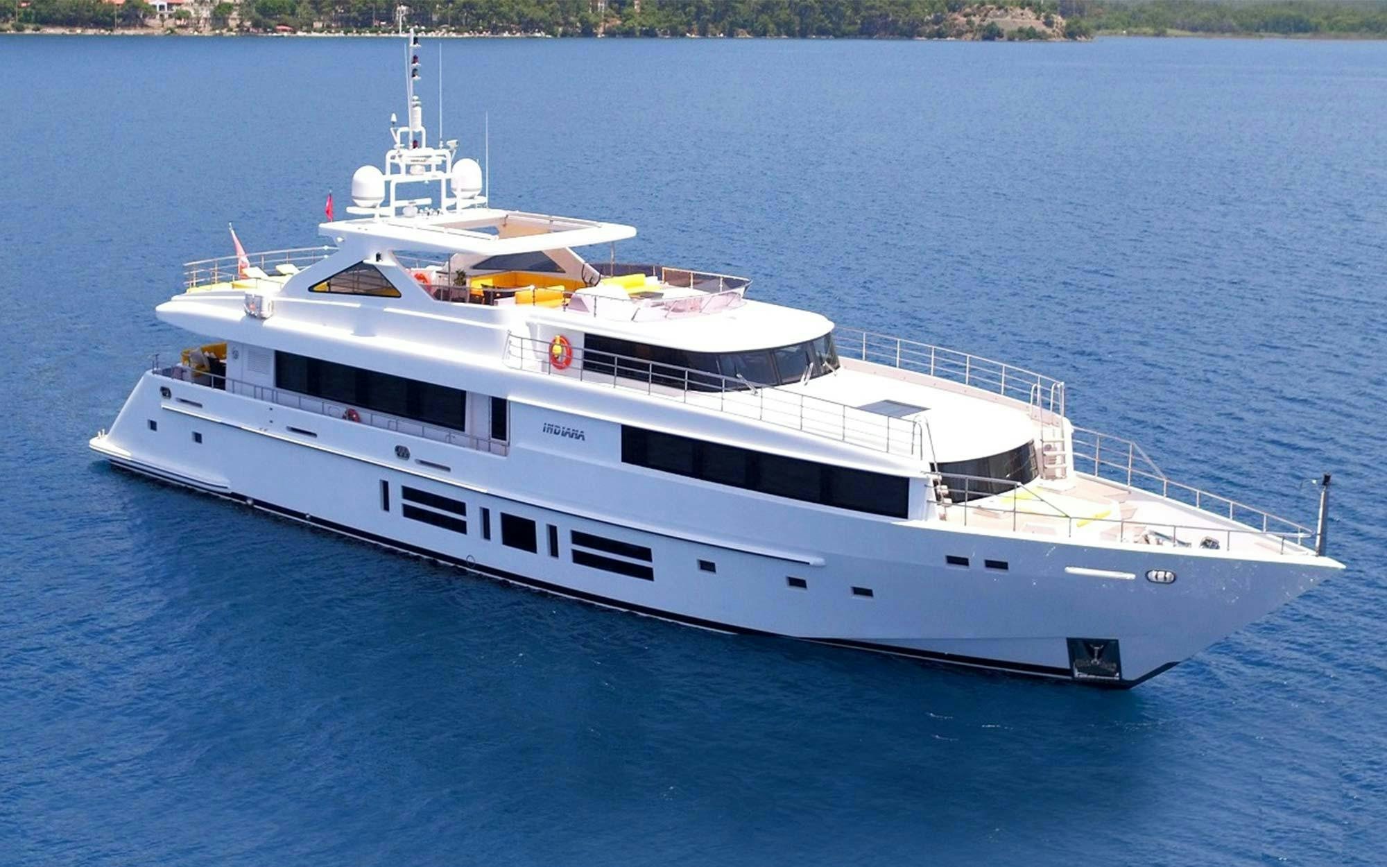 a large white boat on the water aboard INDIANA Yacht for Charter