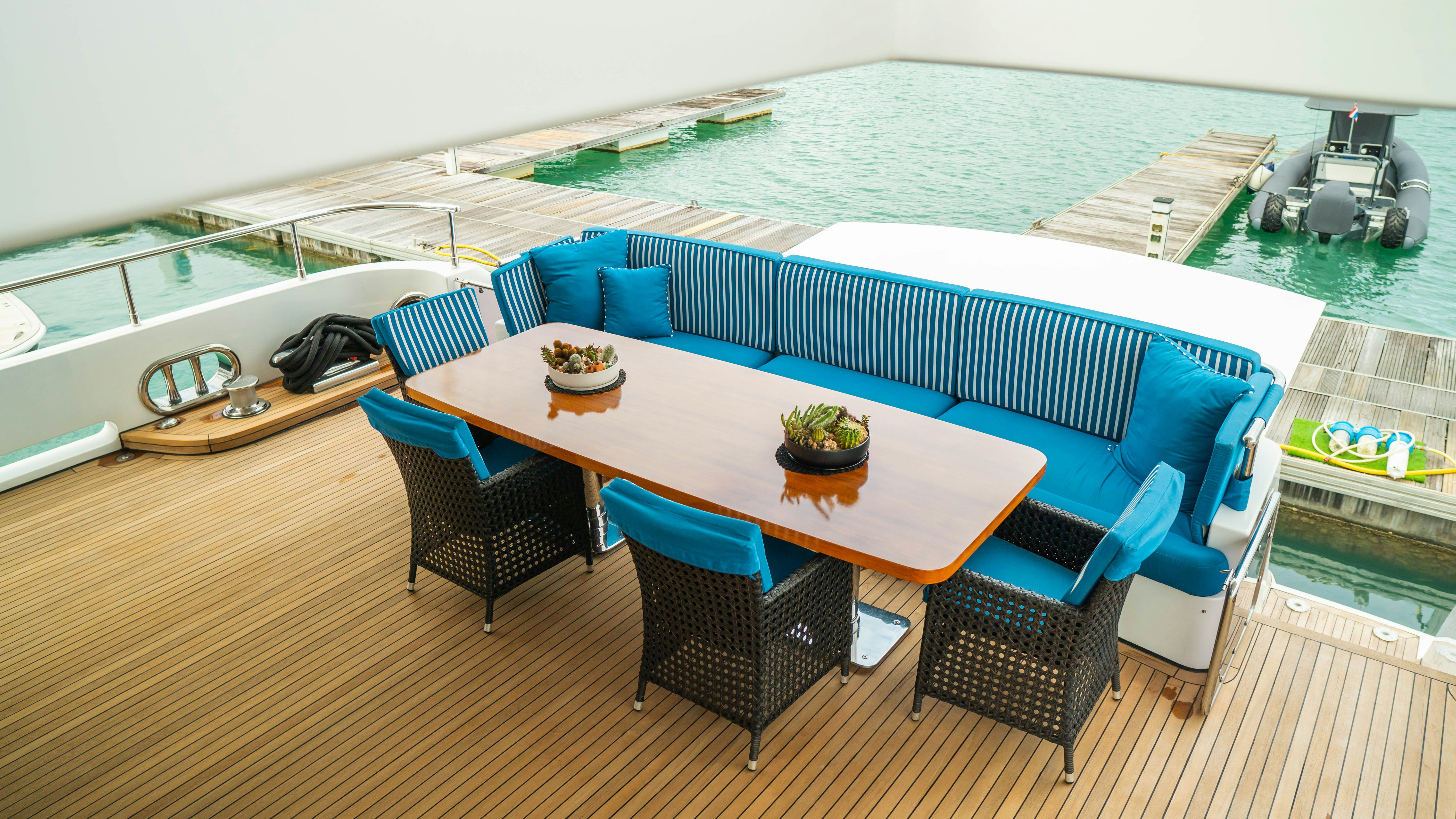 a pool table and chairs on a deck aboard INDIANA Yacht for Charter