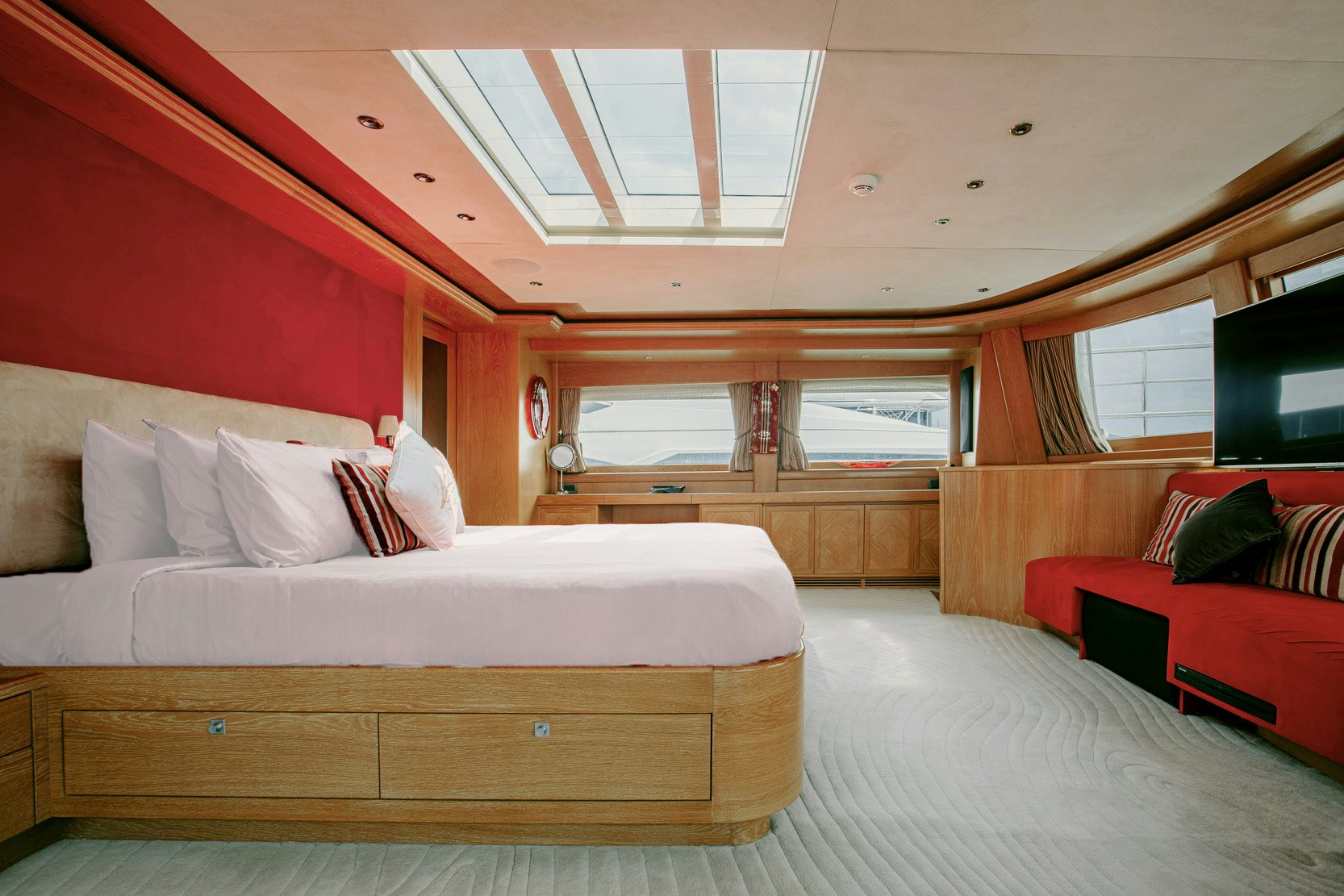 a room with a bed and a couch aboard INDIANA Yacht for Charter