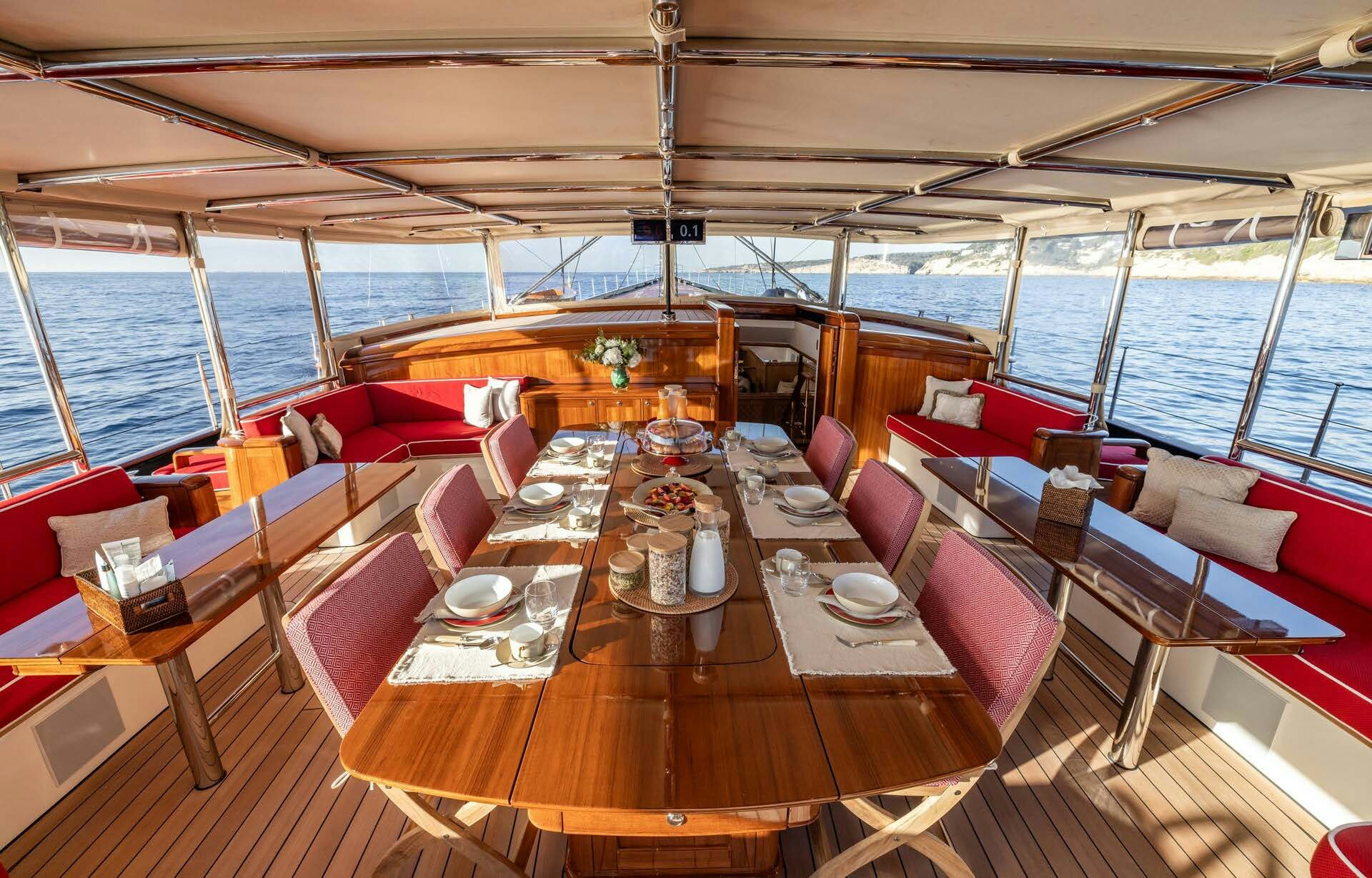 a room with a table and chairs aboard MAXIMUS Yacht for Charter