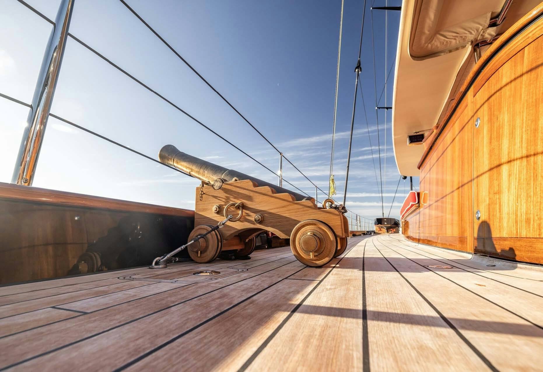 a gun on a wooden deck aboard MAXIMUS Yacht for Charter