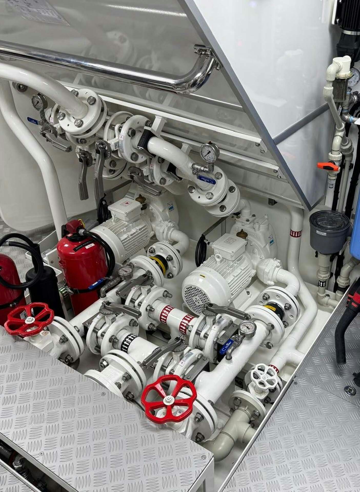 a car engine with a lot of wires and a white board aboard MAXIMUS Yacht for Charter
