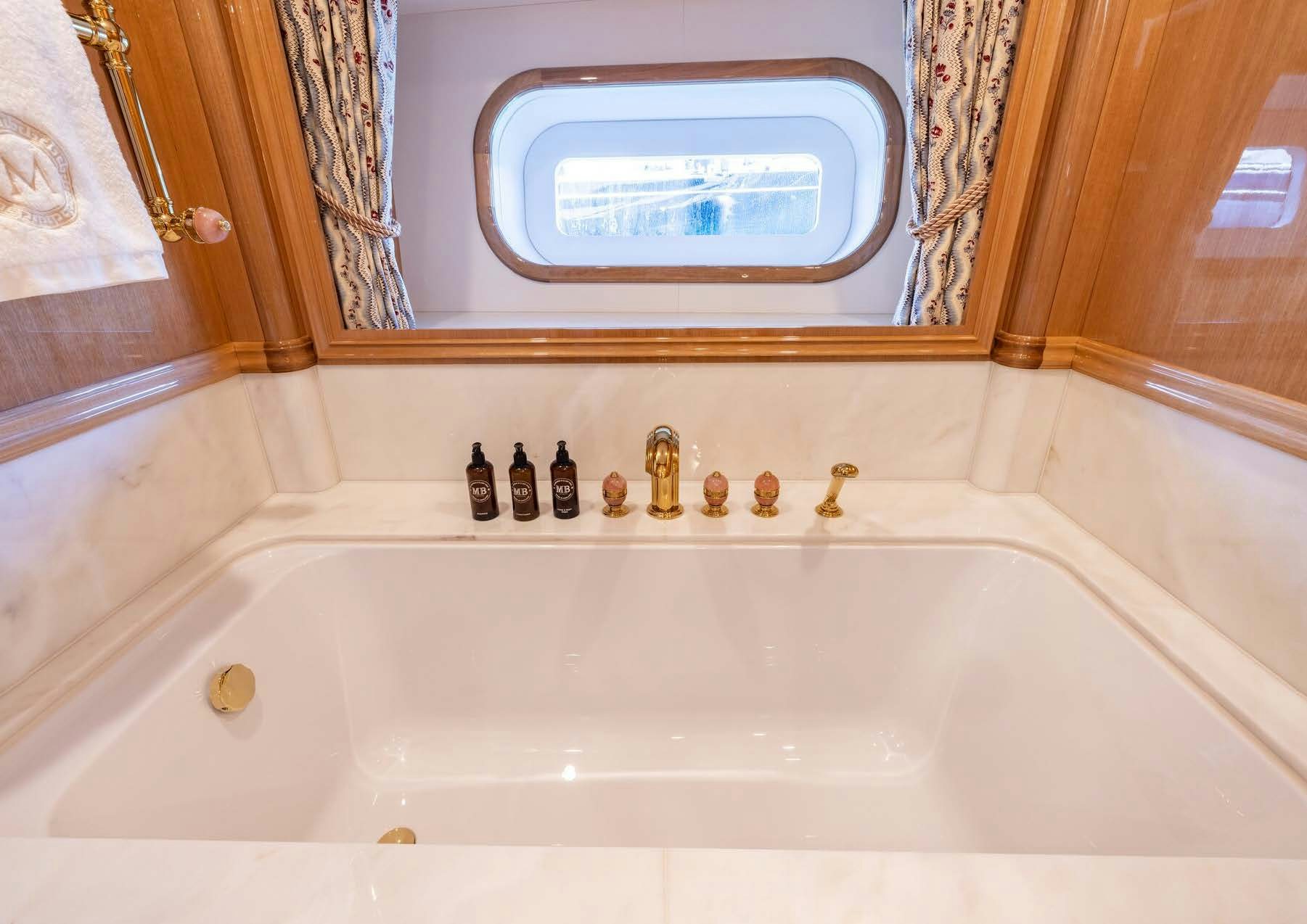 a bathtub with bottles on it aboard MAXIMUS Yacht for Charter