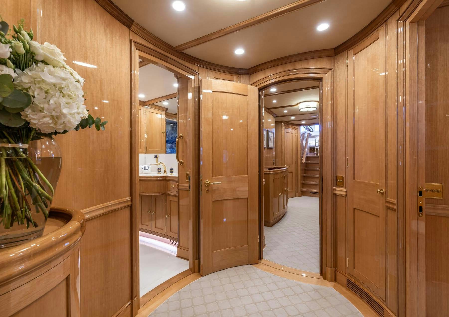 a hallway with wood doors aboard MAXIMUS Yacht for Charter