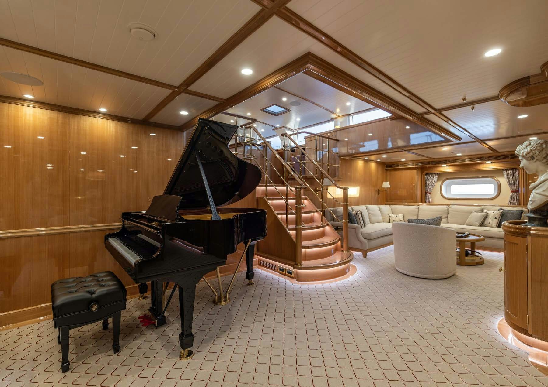 a piano in a room aboard MAXIMUS Yacht for Charter