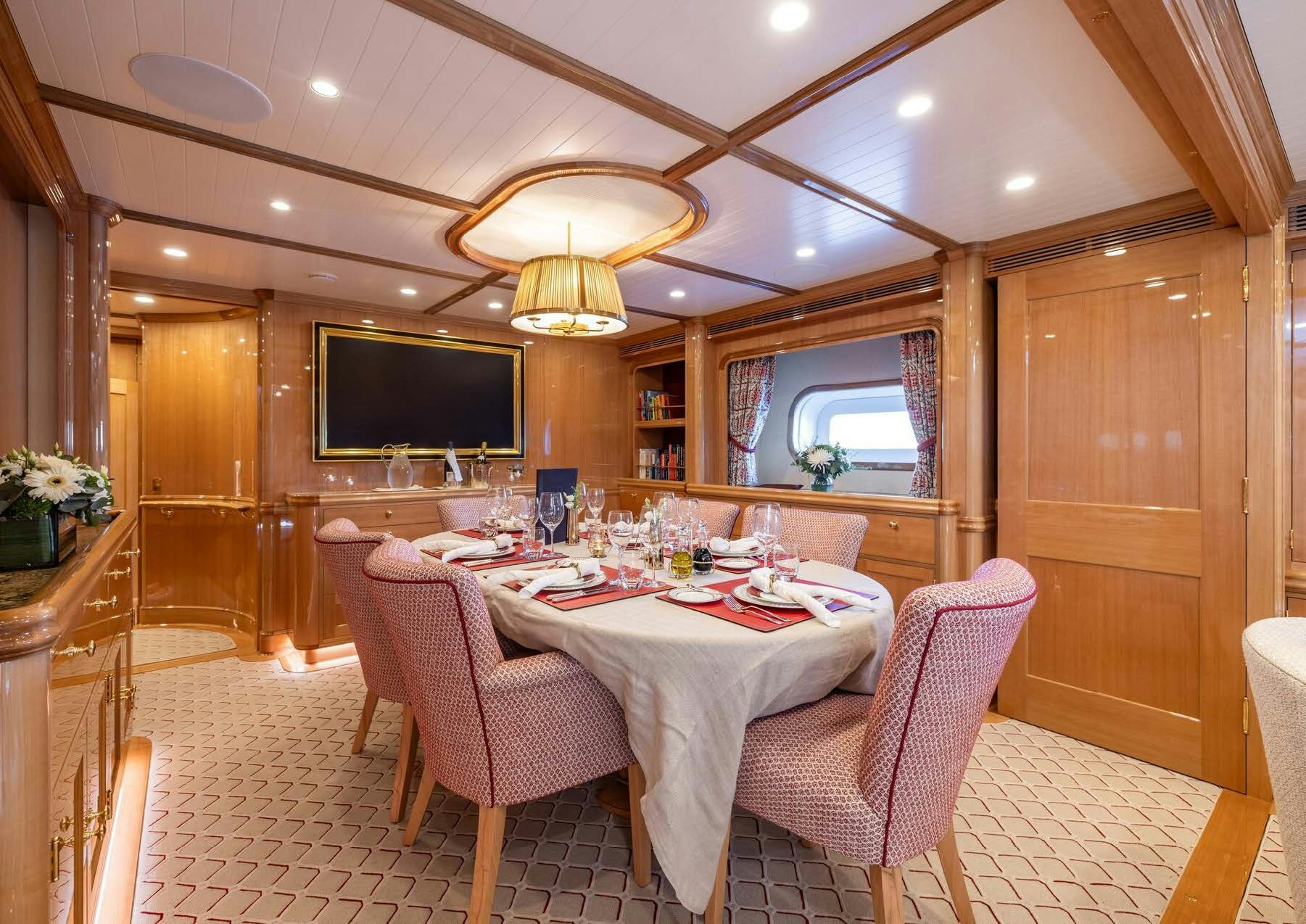 a dining room with a table and chairs aboard MAXIMUS Yacht for Charter