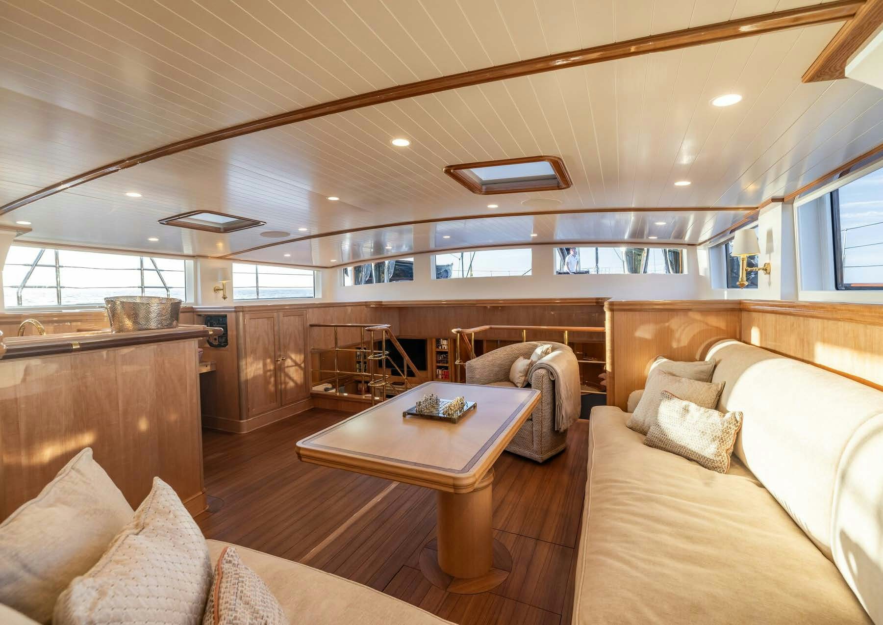 a living room with a wood floor aboard MAXIMUS Yacht for Charter