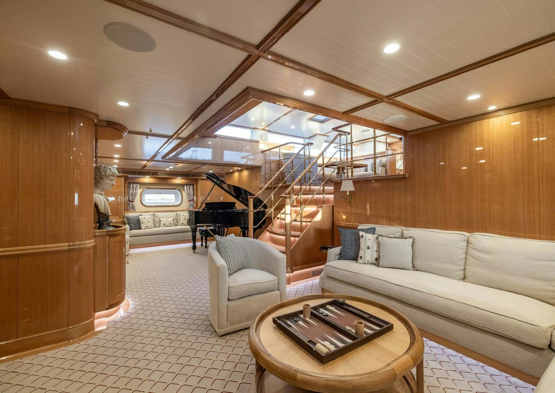 a living room with a staircase aboard MAXIMUS Yacht for Charter
