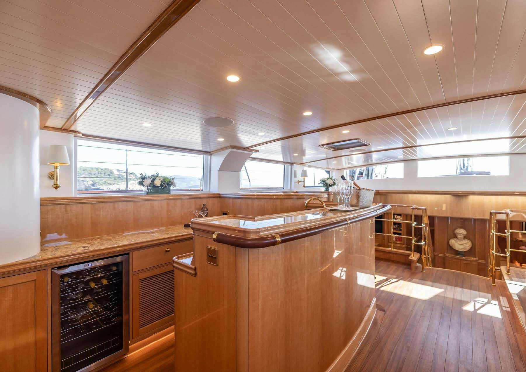 a kitchen with wooden cabinets aboard MAXIMUS Yacht for Charter