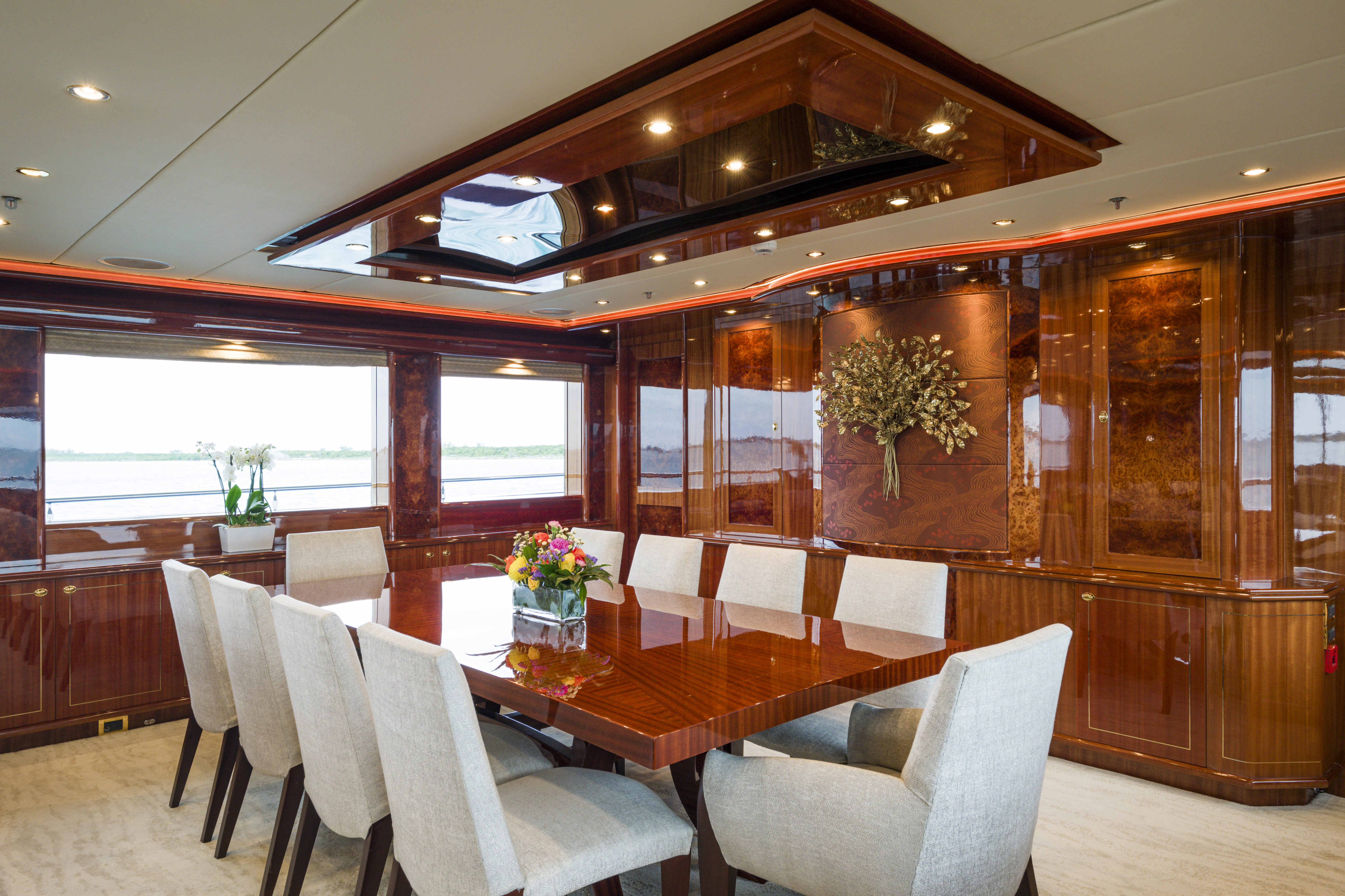 a room with a table chairs and a plant in the middle aboard DUCHESS Yacht for Sale