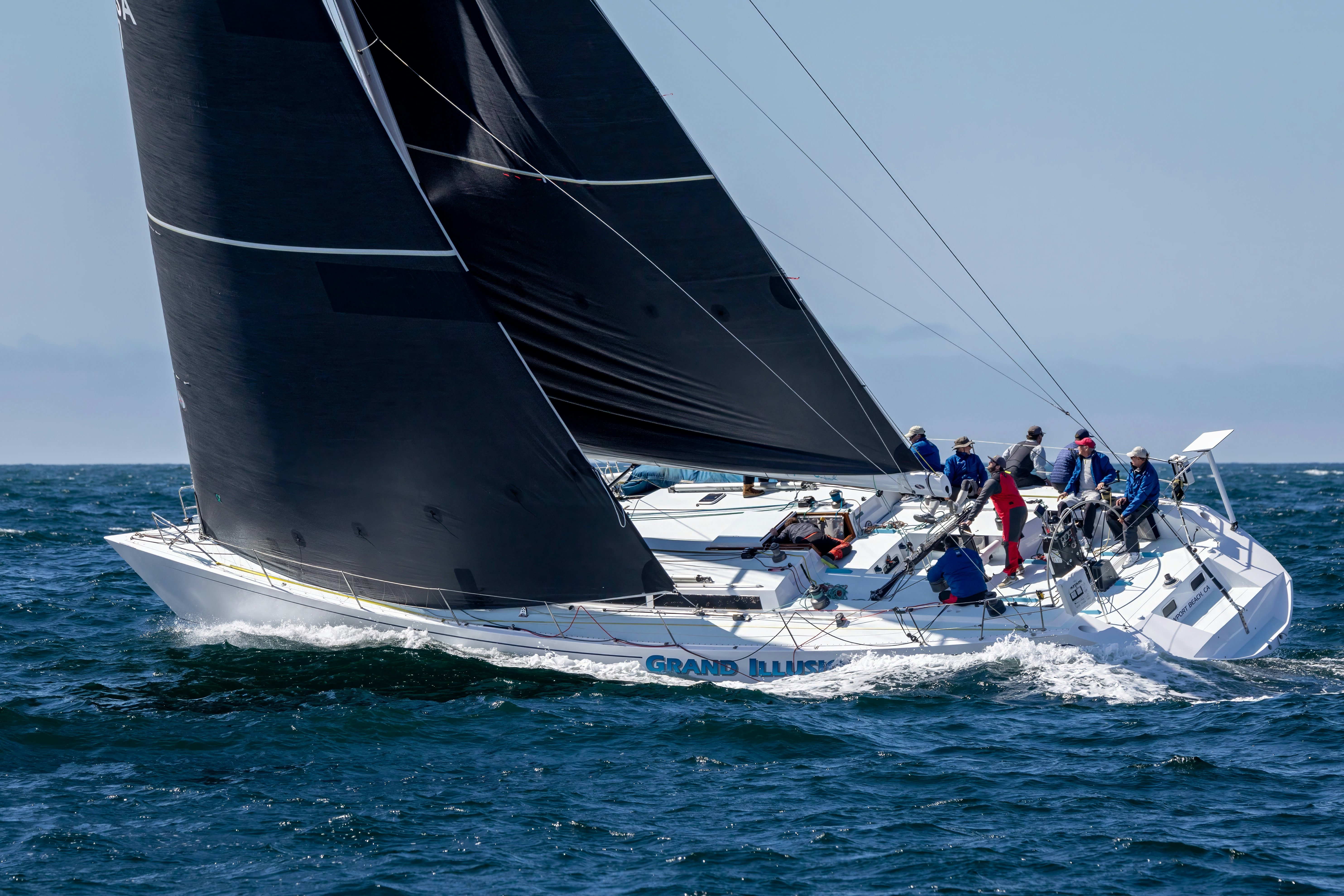 a group of people sailing on a sailboat aboard GRAND ILLUSION Yacht for Sale