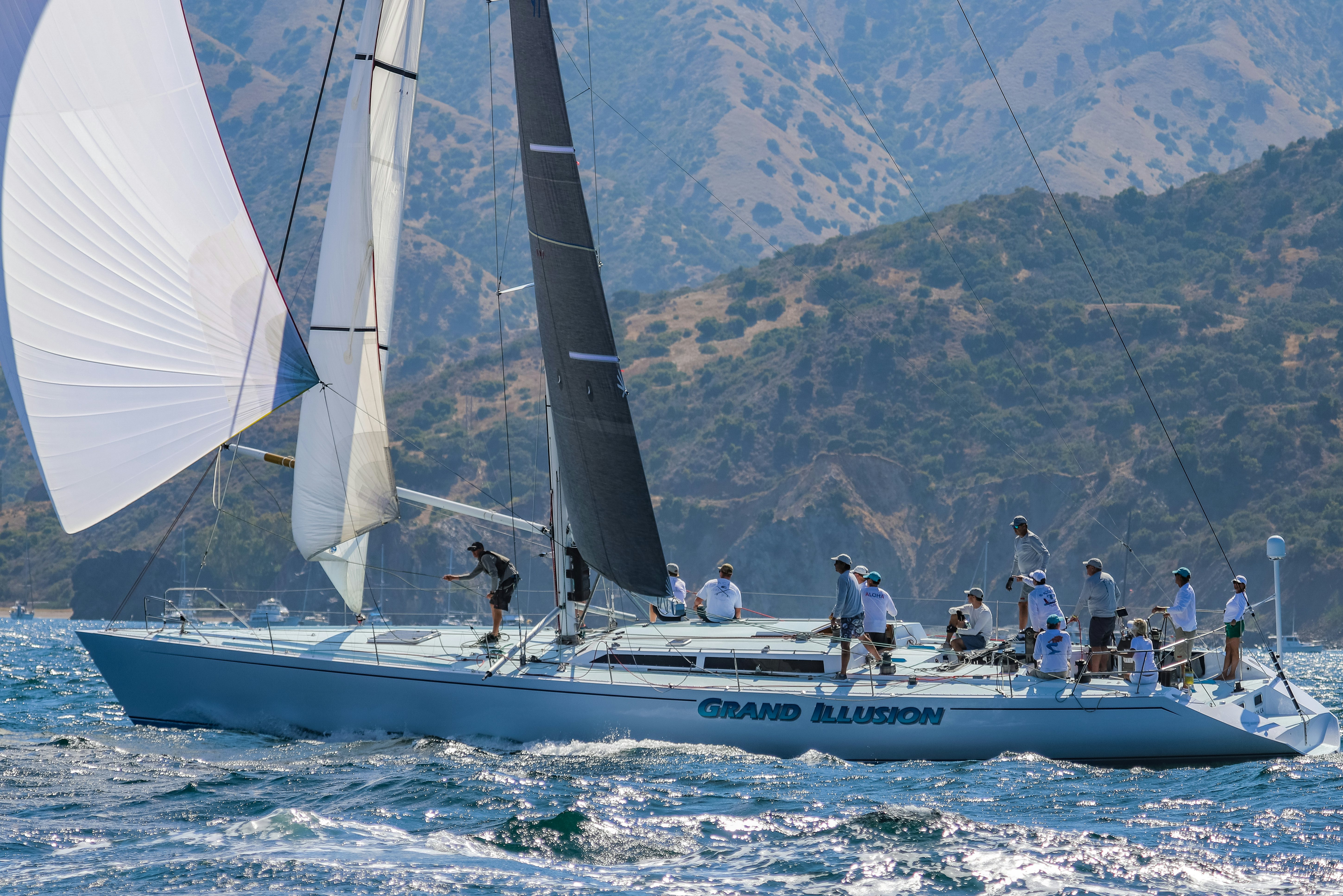 a group of people on a sailboat in the water aboard GRAND ILLUSION Yacht for Sale