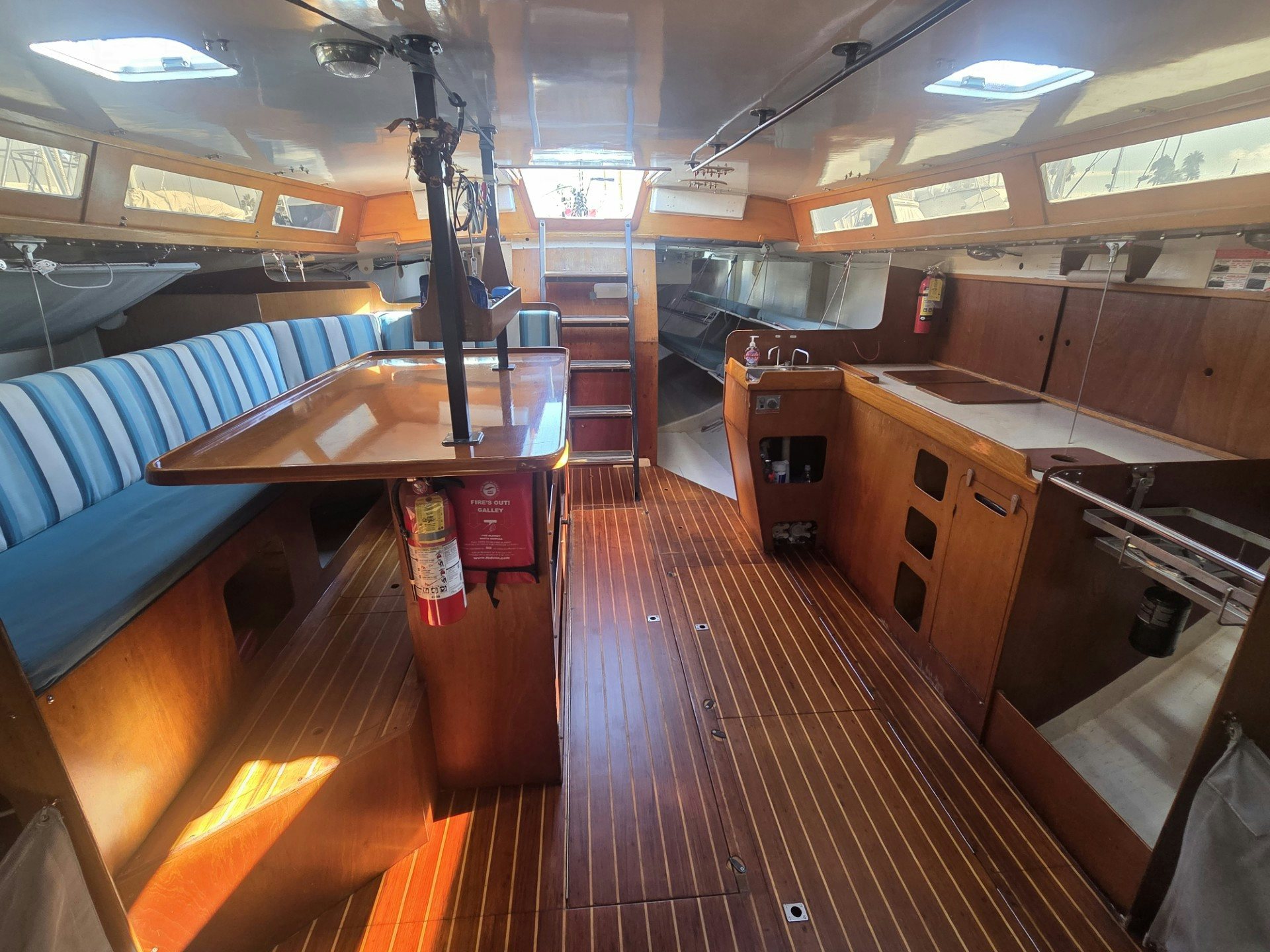 a room with a table and a bench aboard GRAND ILLUSION Yacht for Sale
