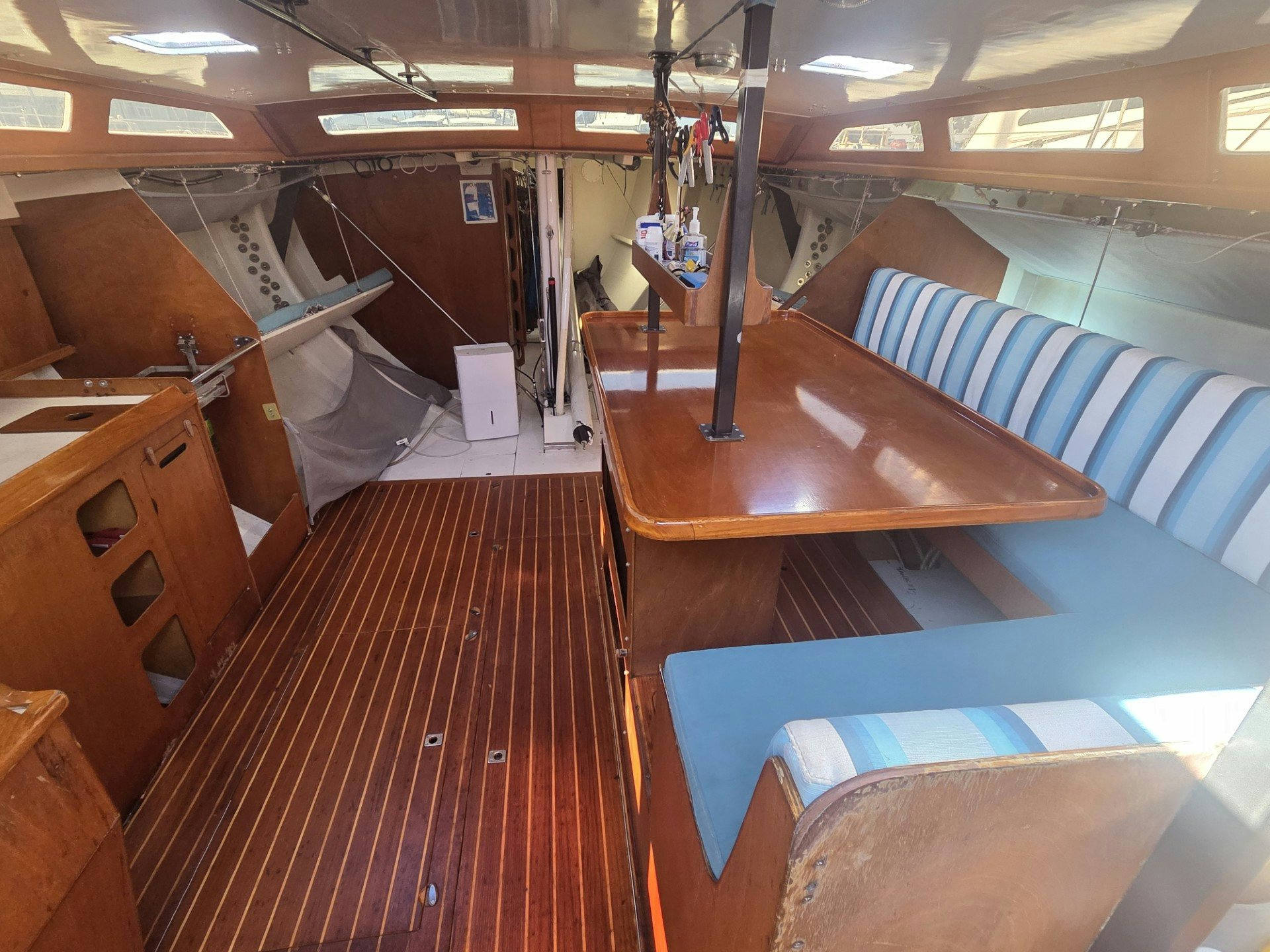 a room with a wood table and chairs aboard GRAND ILLUSION Yacht for Sale