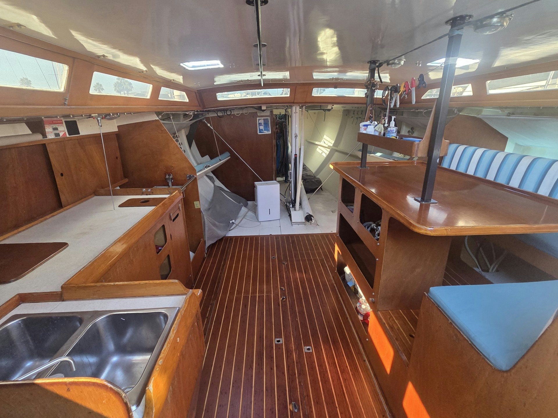 a room with wooden tables and chairs aboard GRAND ILLUSION Yacht for Sale
