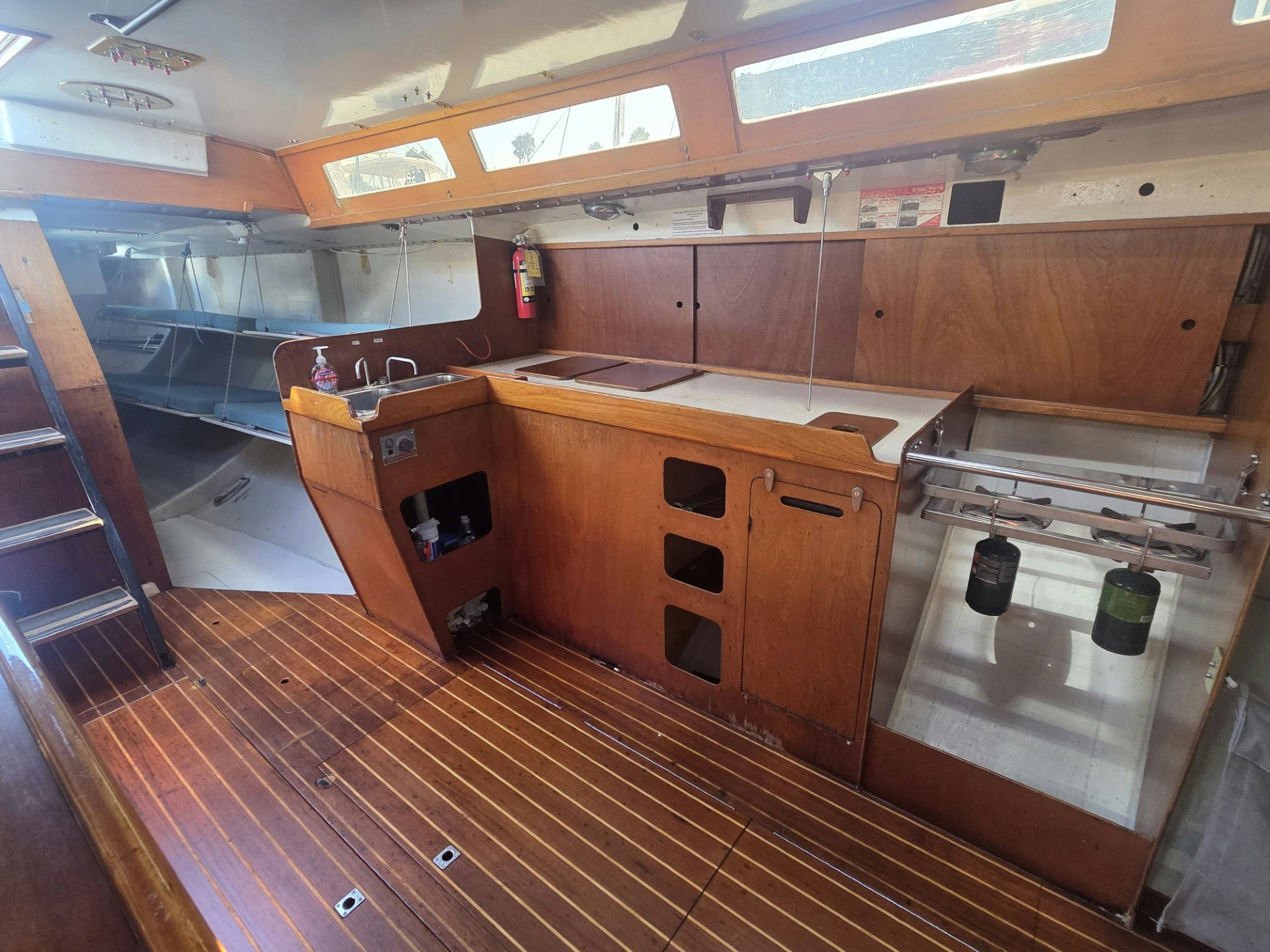 a kitchen with wooden cabinets aboard GRAND ILLUSION Yacht for Sale