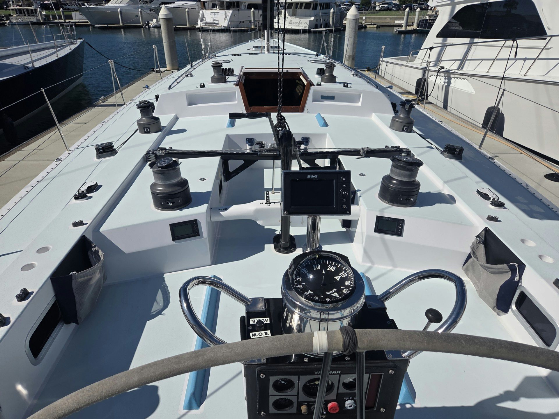 a white boat with black and silver parts aboard GRAND ILLUSION Yacht for Sale