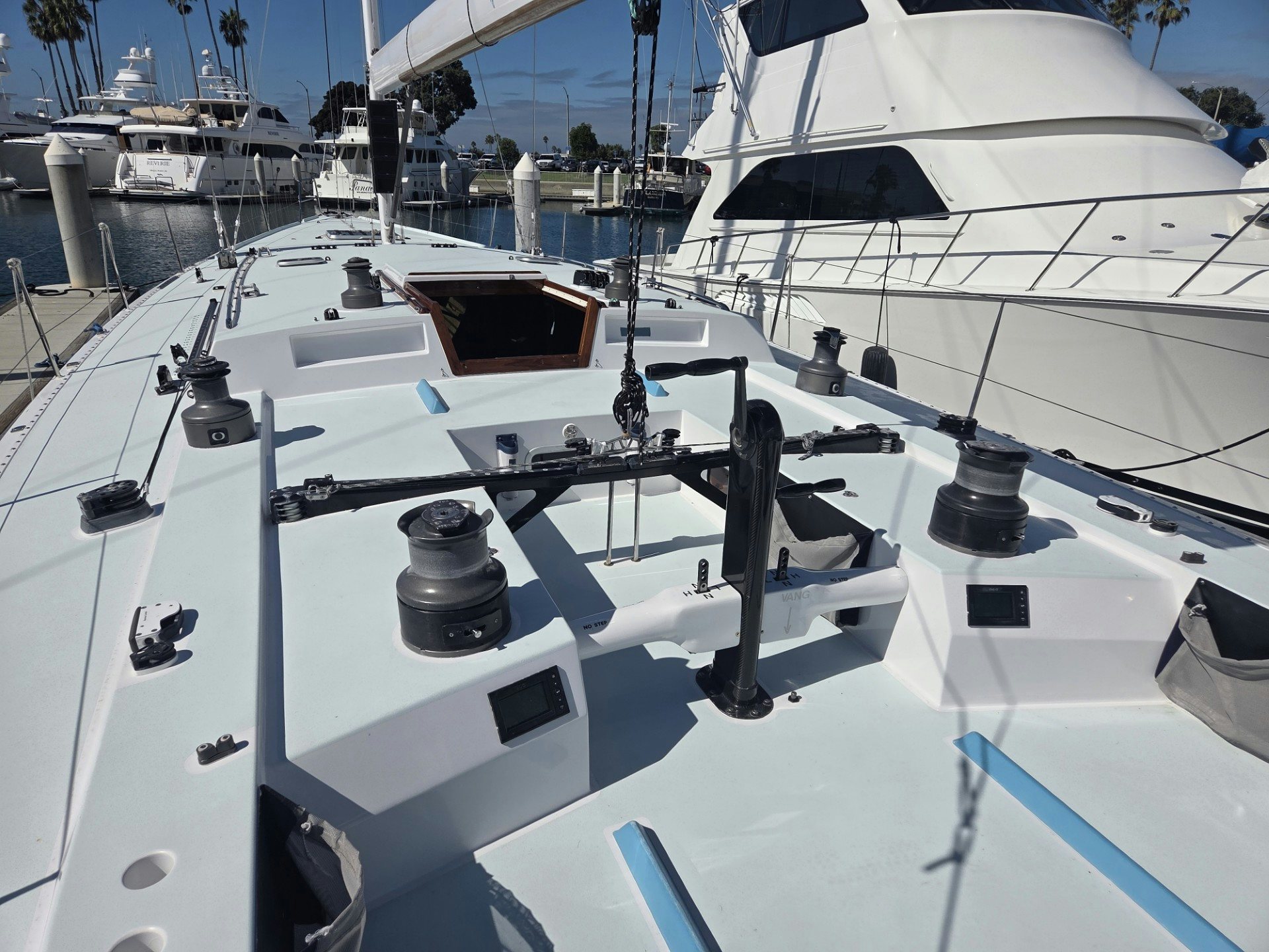 a white boat with black and white sails on a snowy day aboard GRAND ILLUSION Yacht for Sale