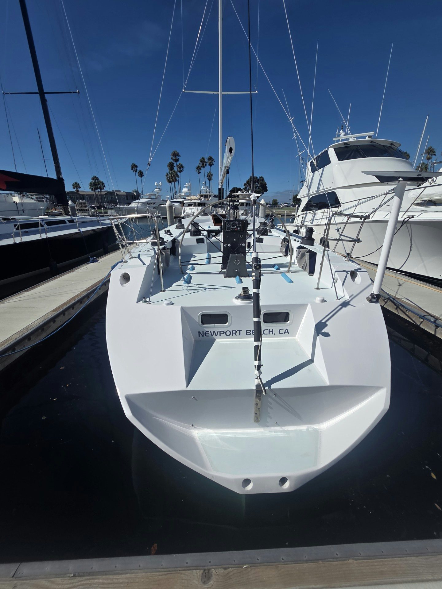 a white boat in a harbor aboard GRAND ILLUSION Yacht for Sale