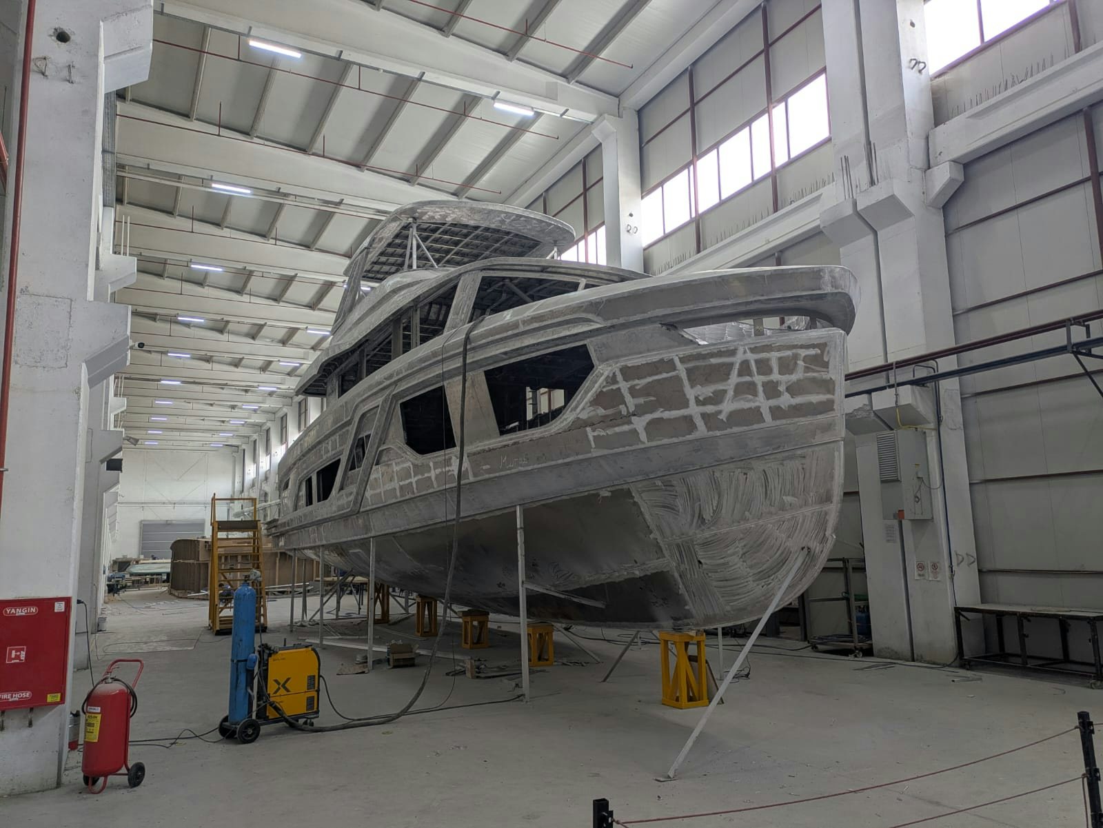 a large white helicopter in a warehouse aboard SANCREA 70 Yacht for Sale