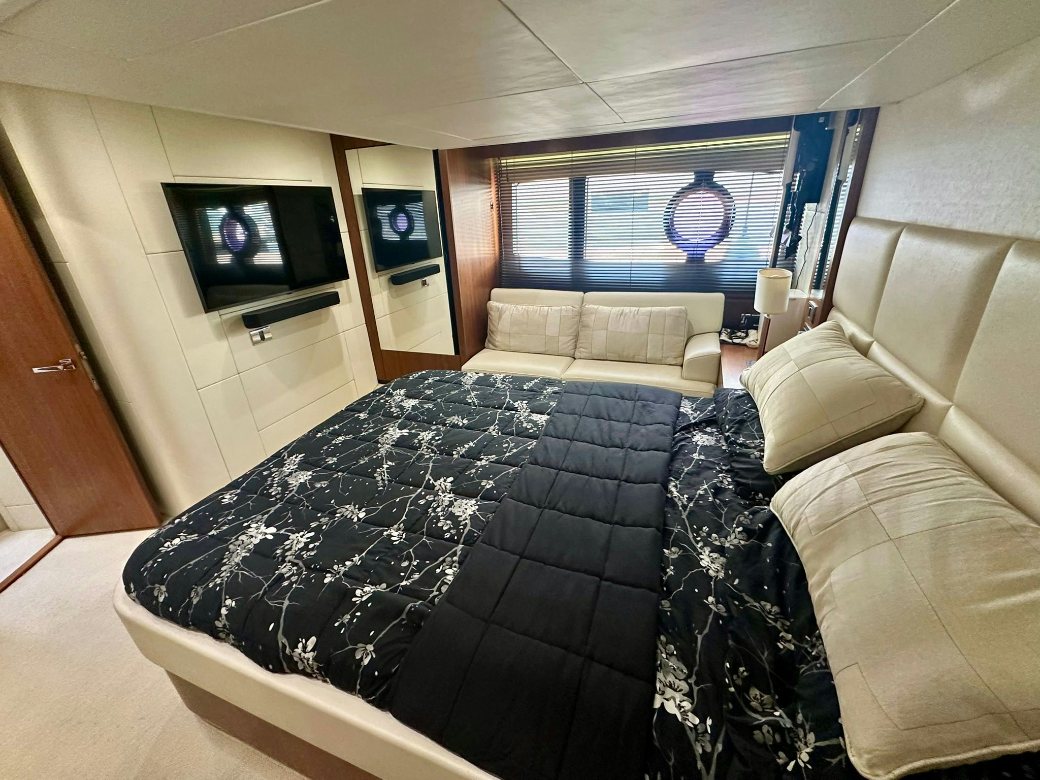 a room with a bed and a tv on the wall aboard QUICKSILVER I Yacht for Sale