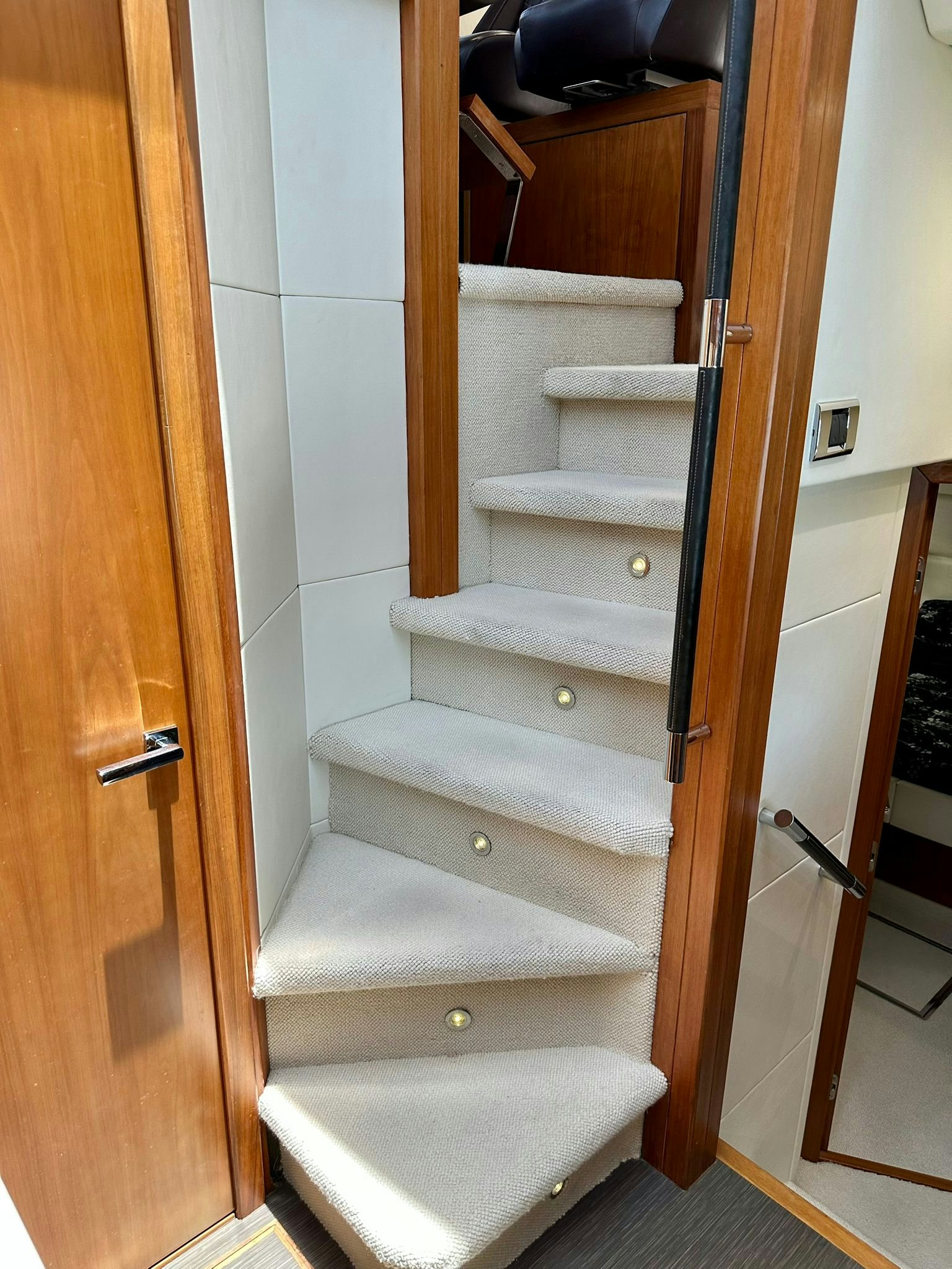 a white staircase with a wood door aboard QUICKSILVER I Yacht for Sale