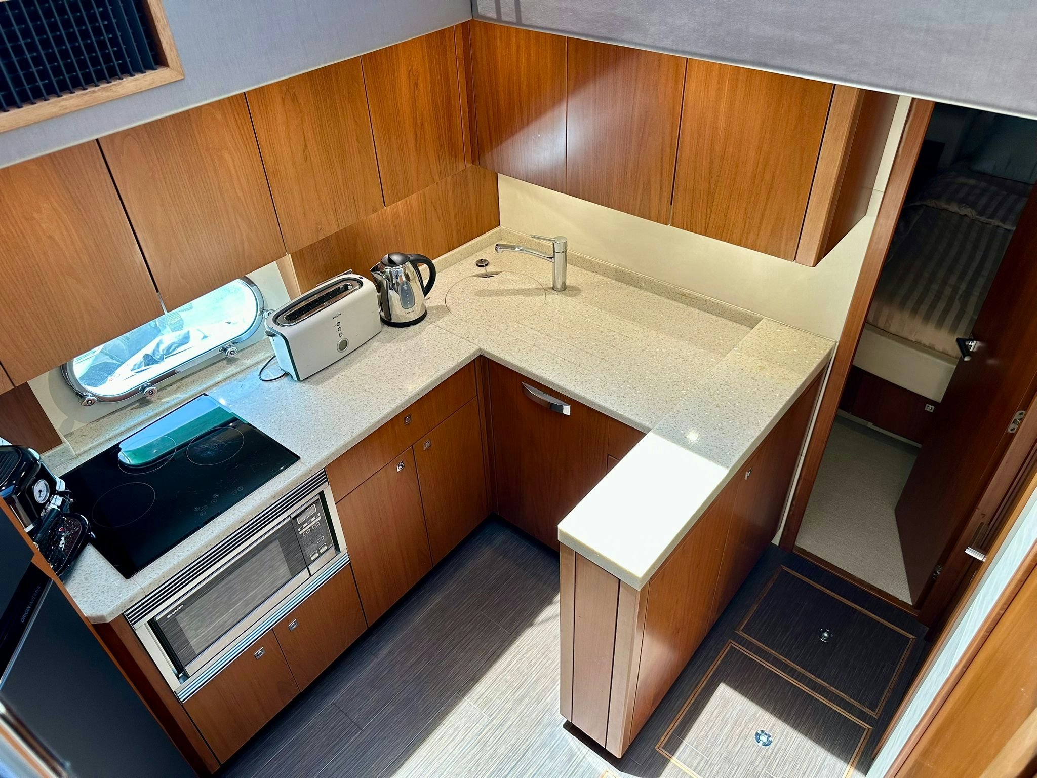 a kitchen with wooden cabinets aboard QUICKSILVER I Yacht for Sale