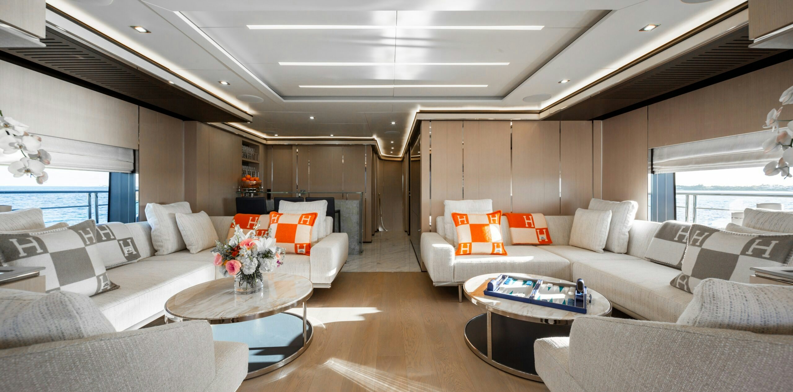 a living room with white couches and a table aboard PROVOCATEUR Yacht for Charter