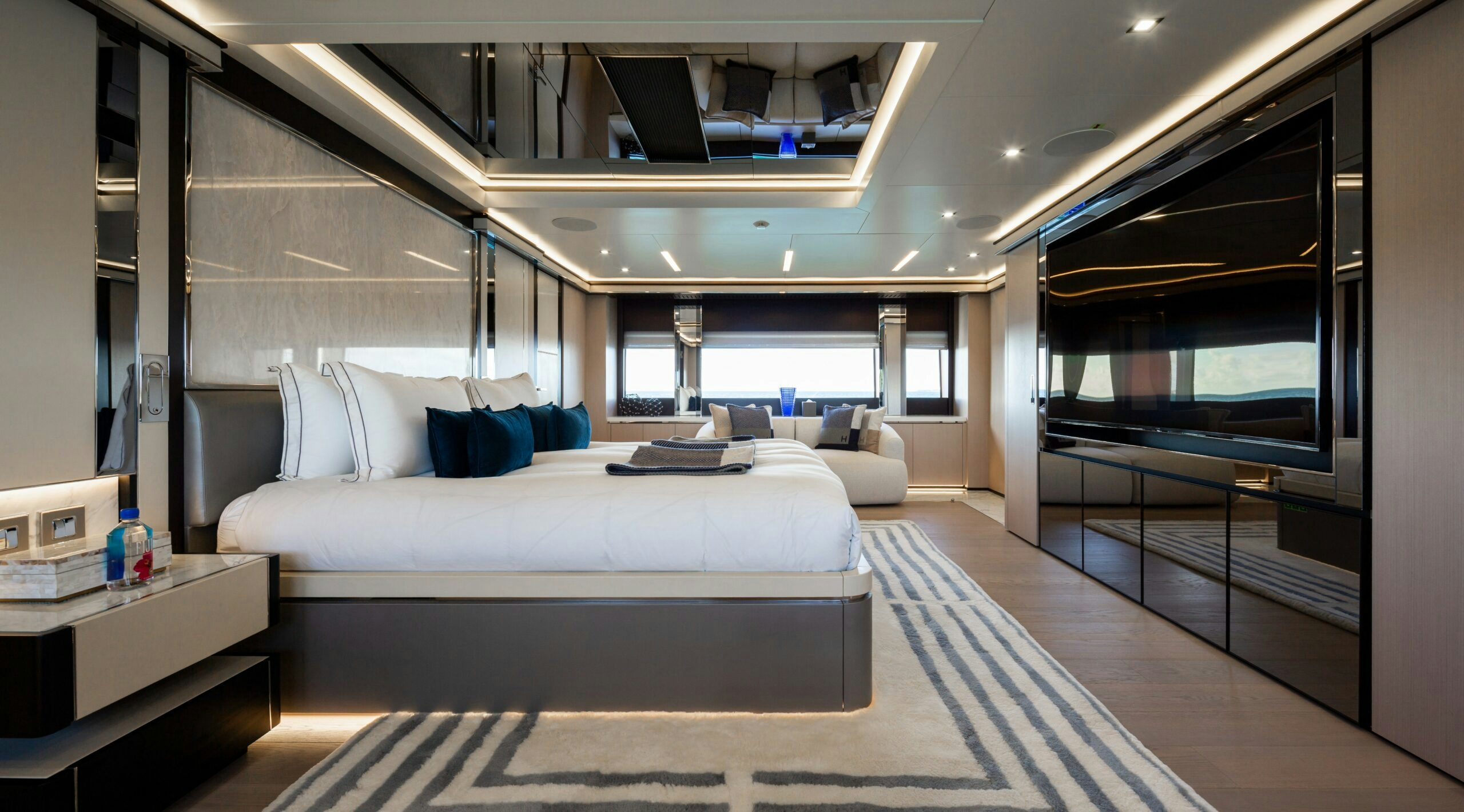 a room with a bed and a large mirror aboard PROVOCATEUR Yacht for Charter