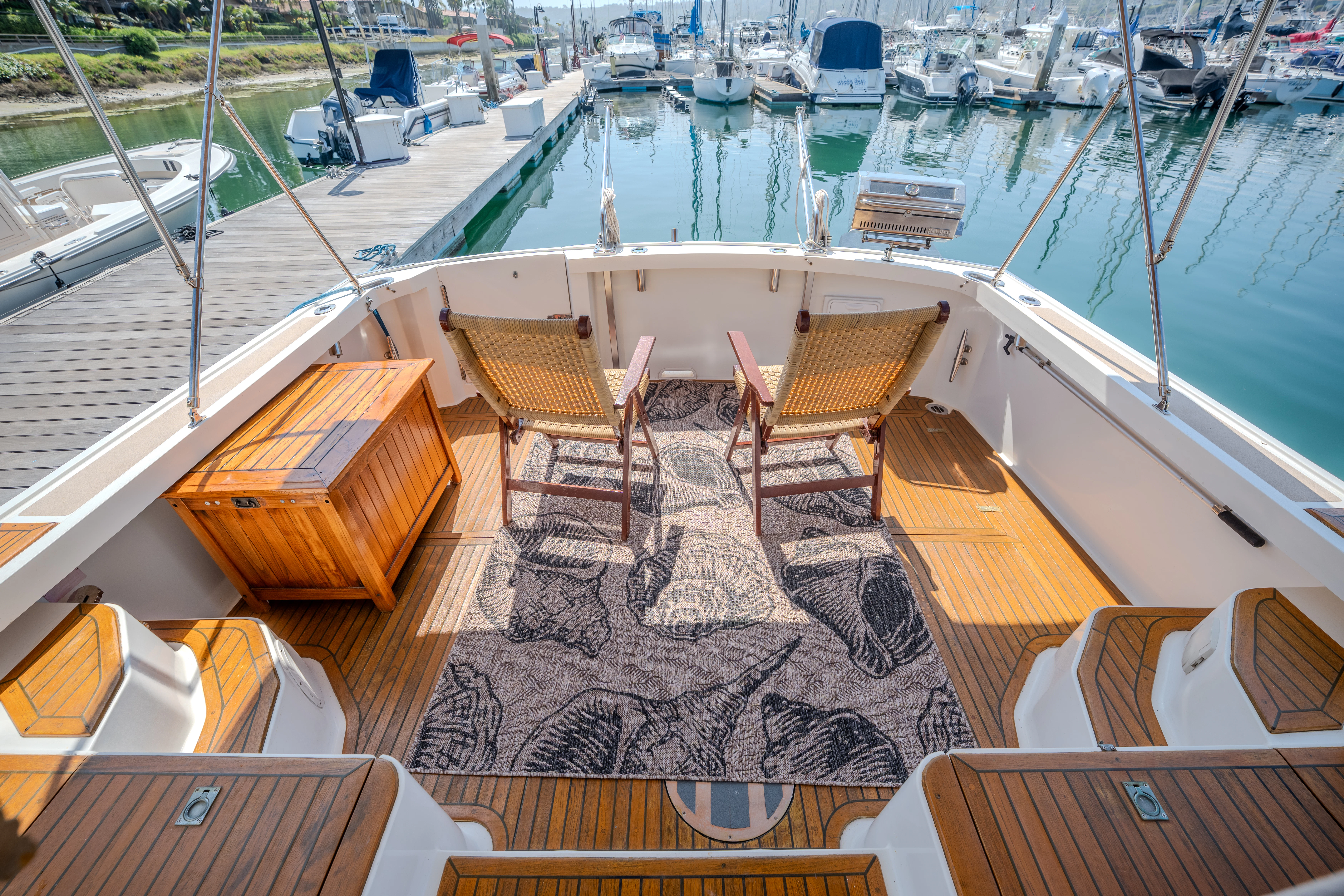 a deck with chairs and tables on it aboard OSPREY Yacht for Sale