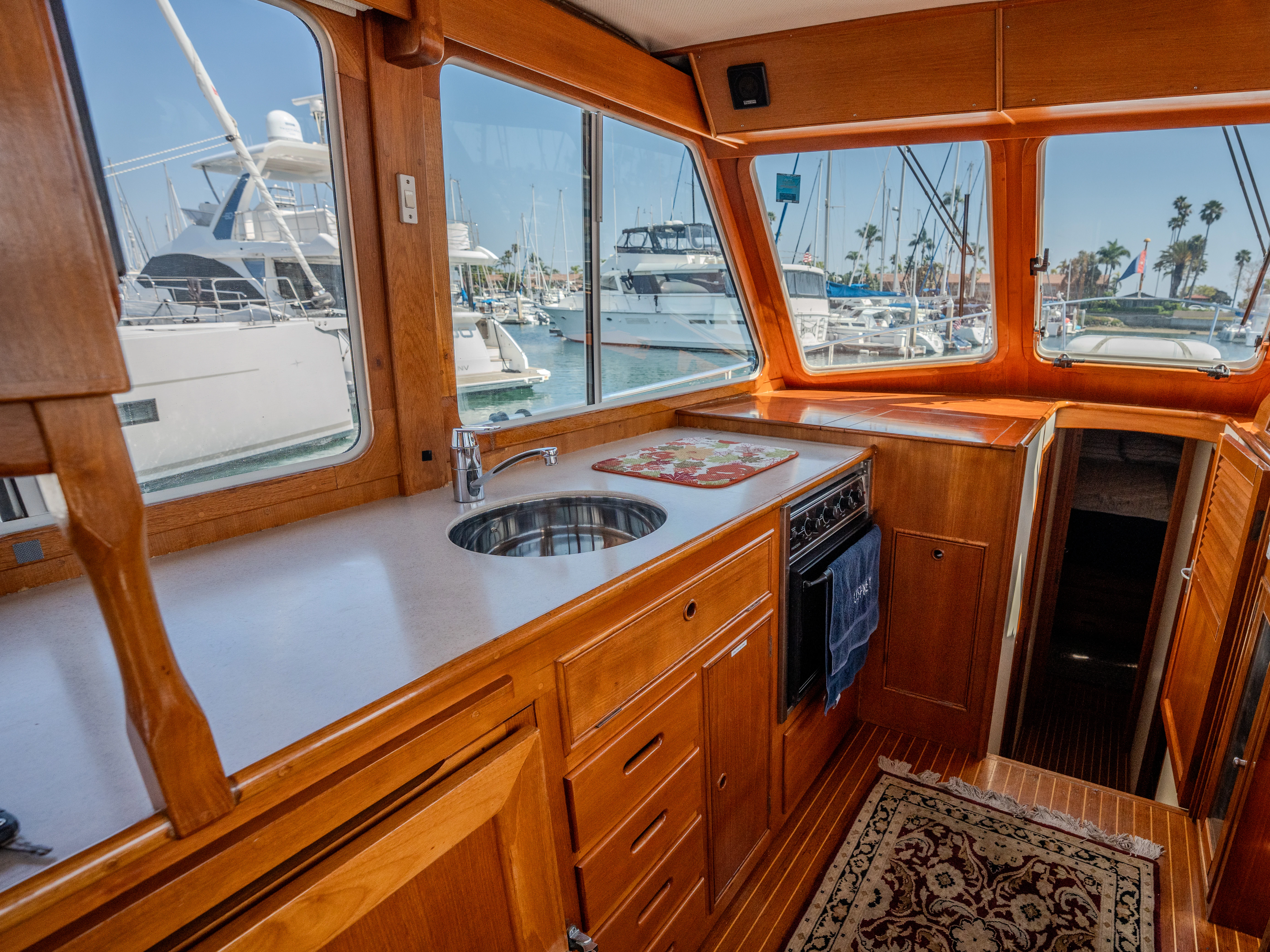 a kitchen with wooden cabinets aboard OSPREY Yacht for Sale