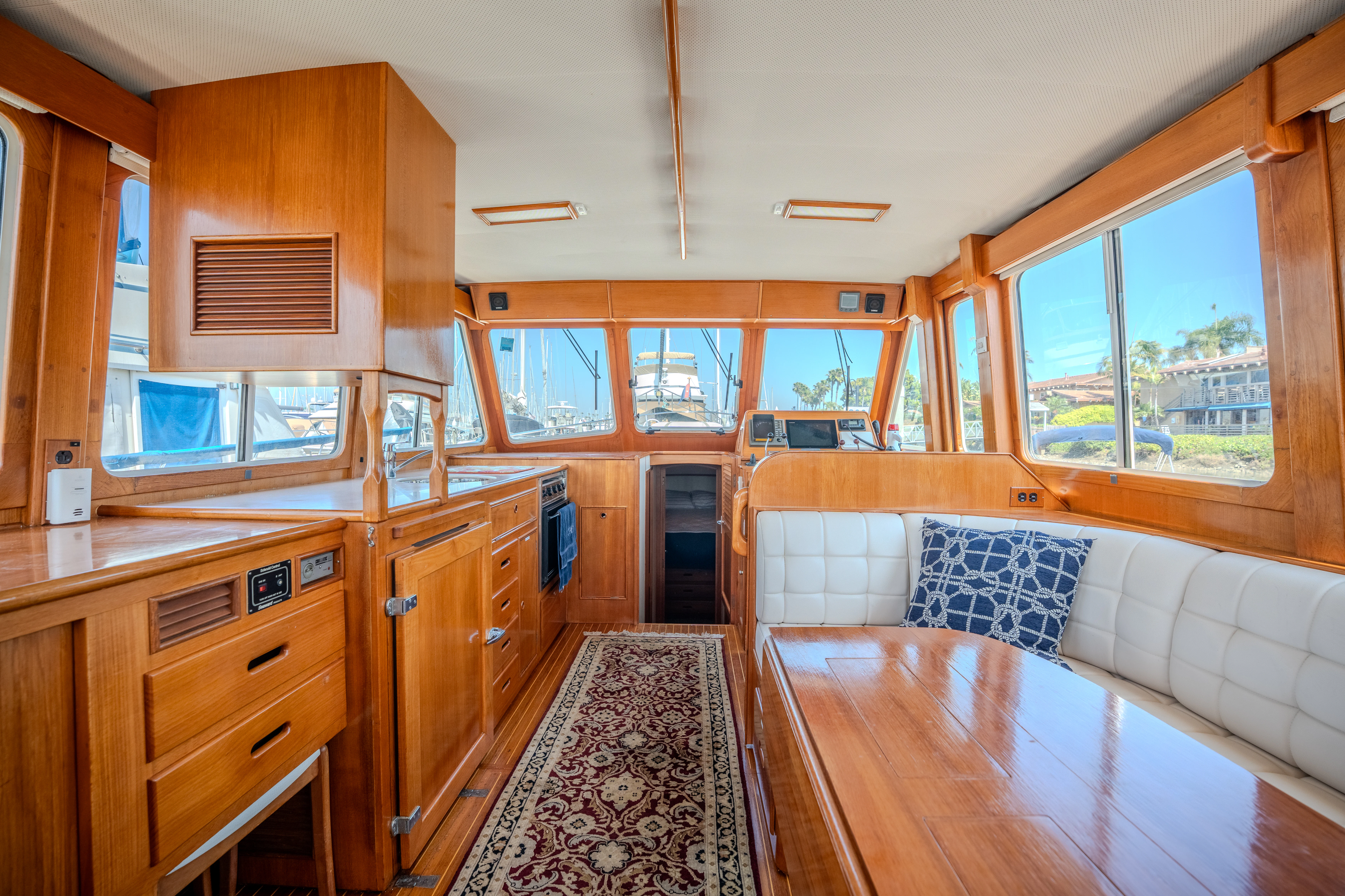 a kitchen with wooden cabinets aboard OSPREY Yacht for Sale