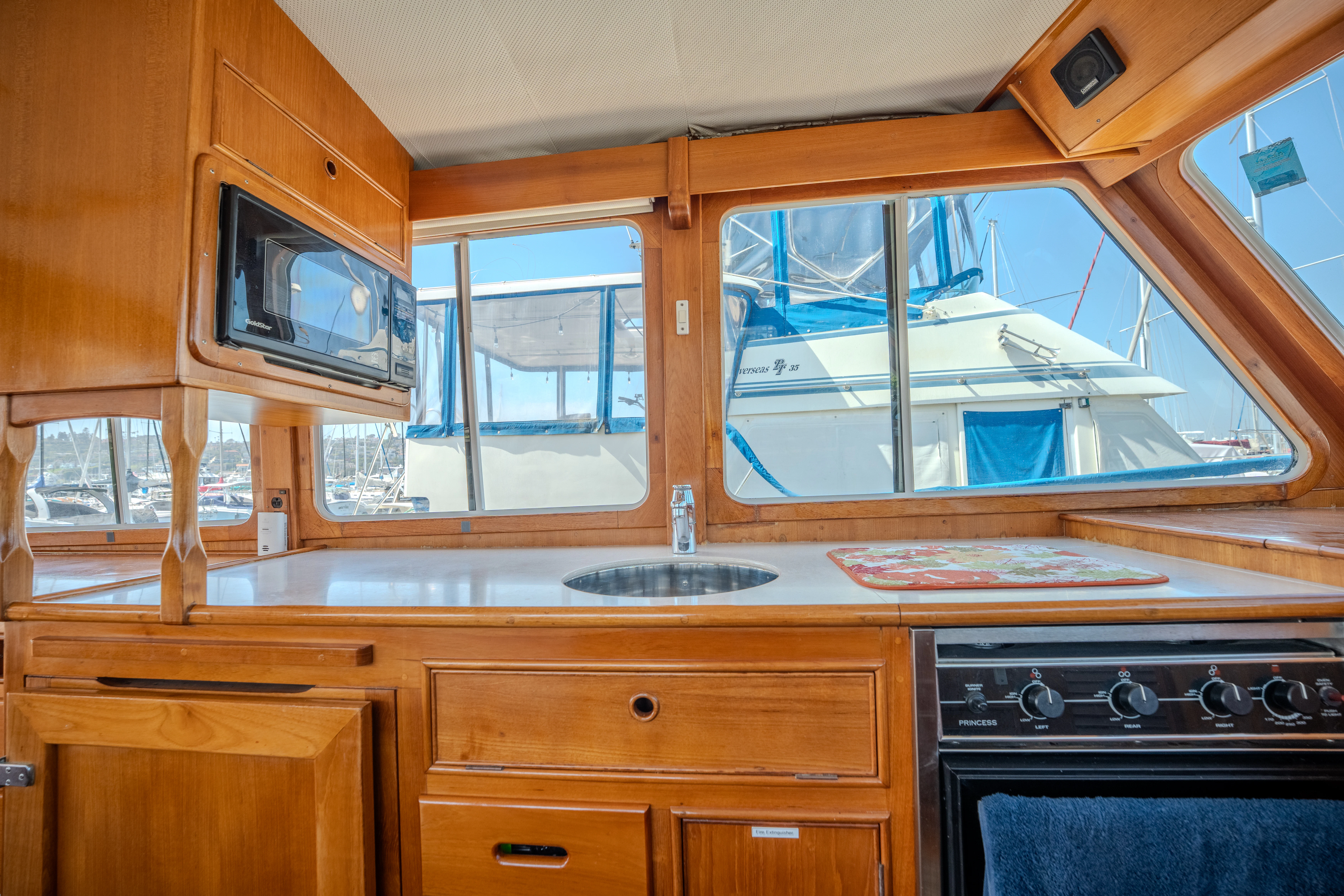 a kitchen with wooden cabinets aboard OSPREY Yacht for Sale