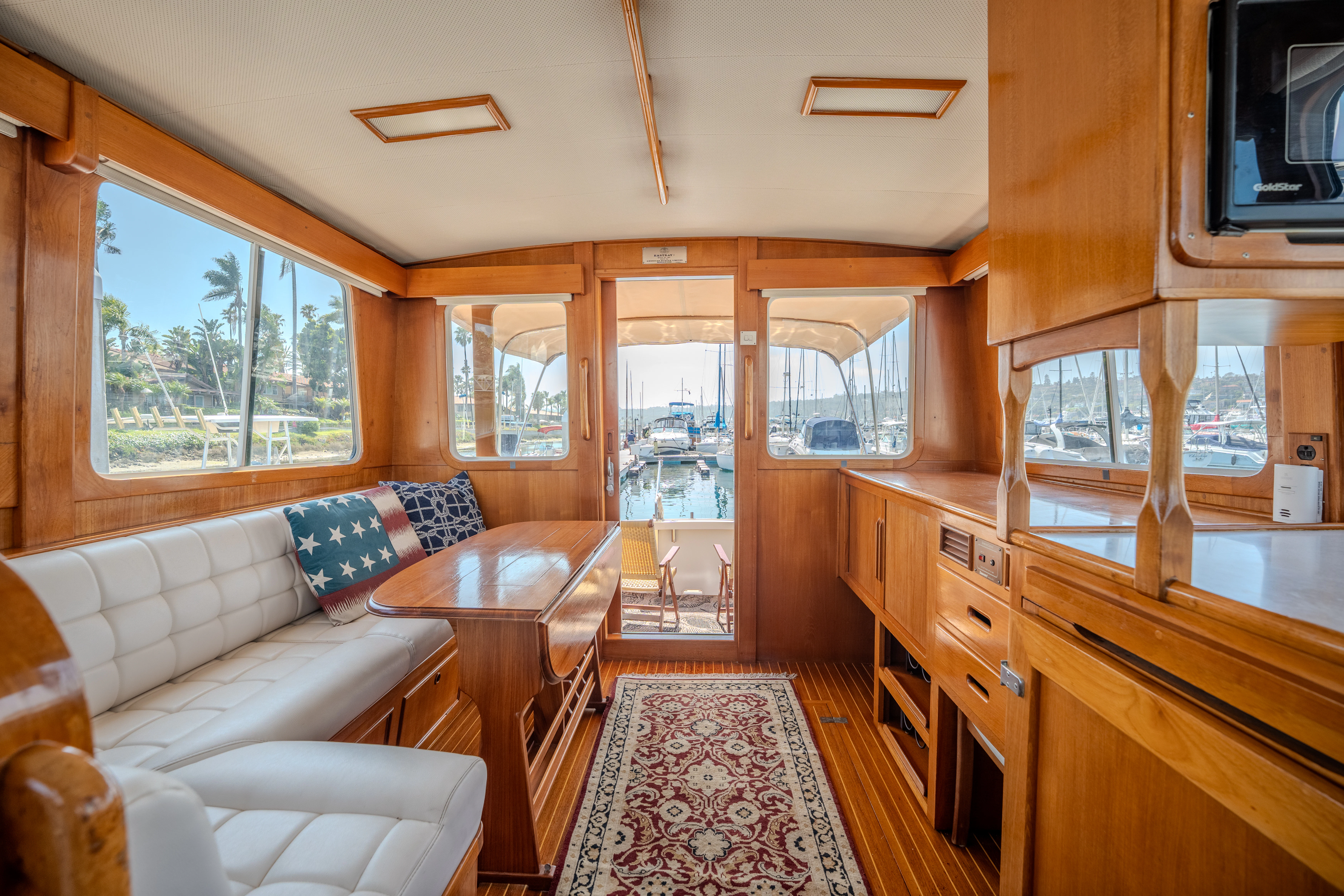 a living room with a kitchen and dining area aboard OSPREY Yacht for Sale