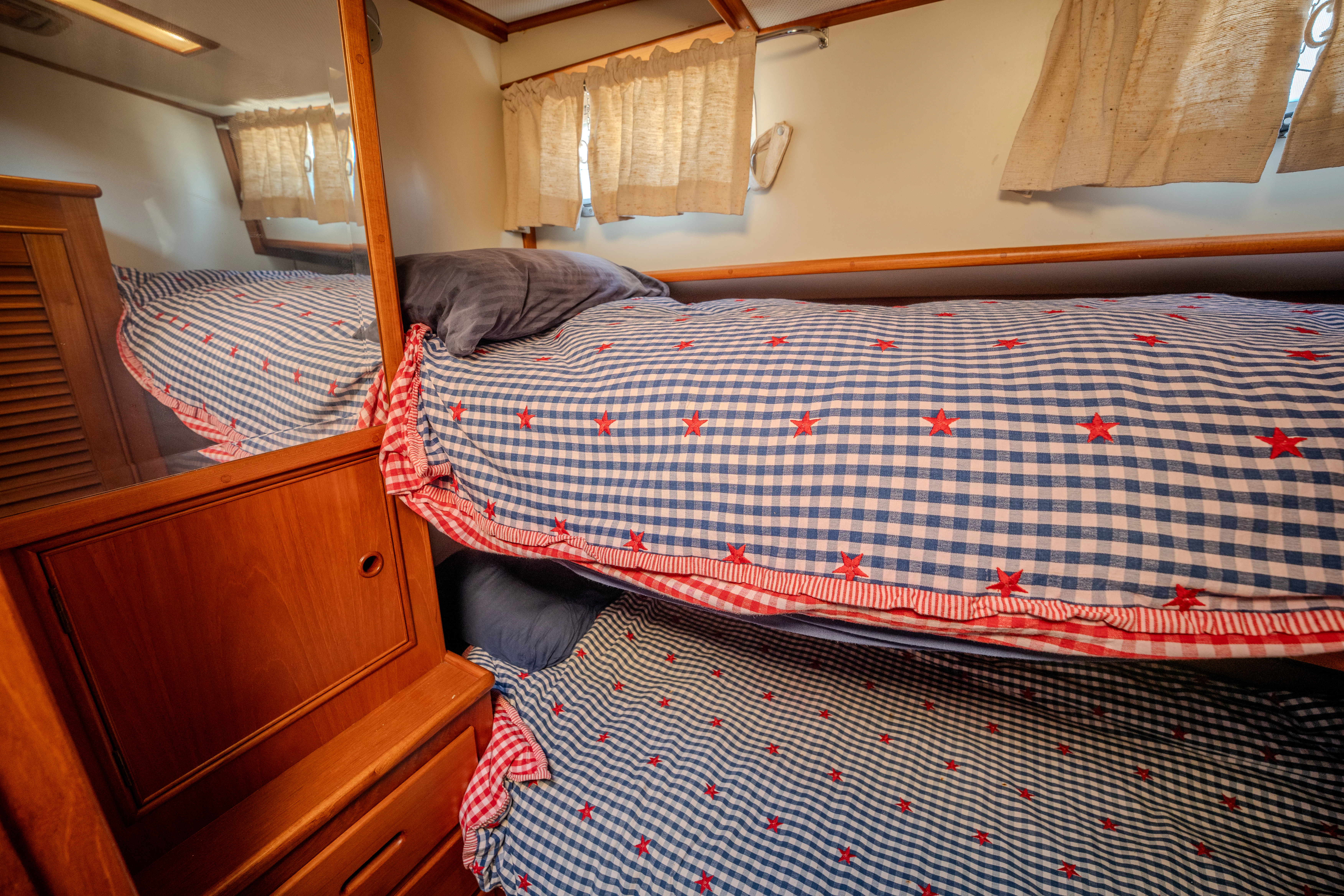 a bed with a plaid sheet aboard OSPREY Yacht for Sale
