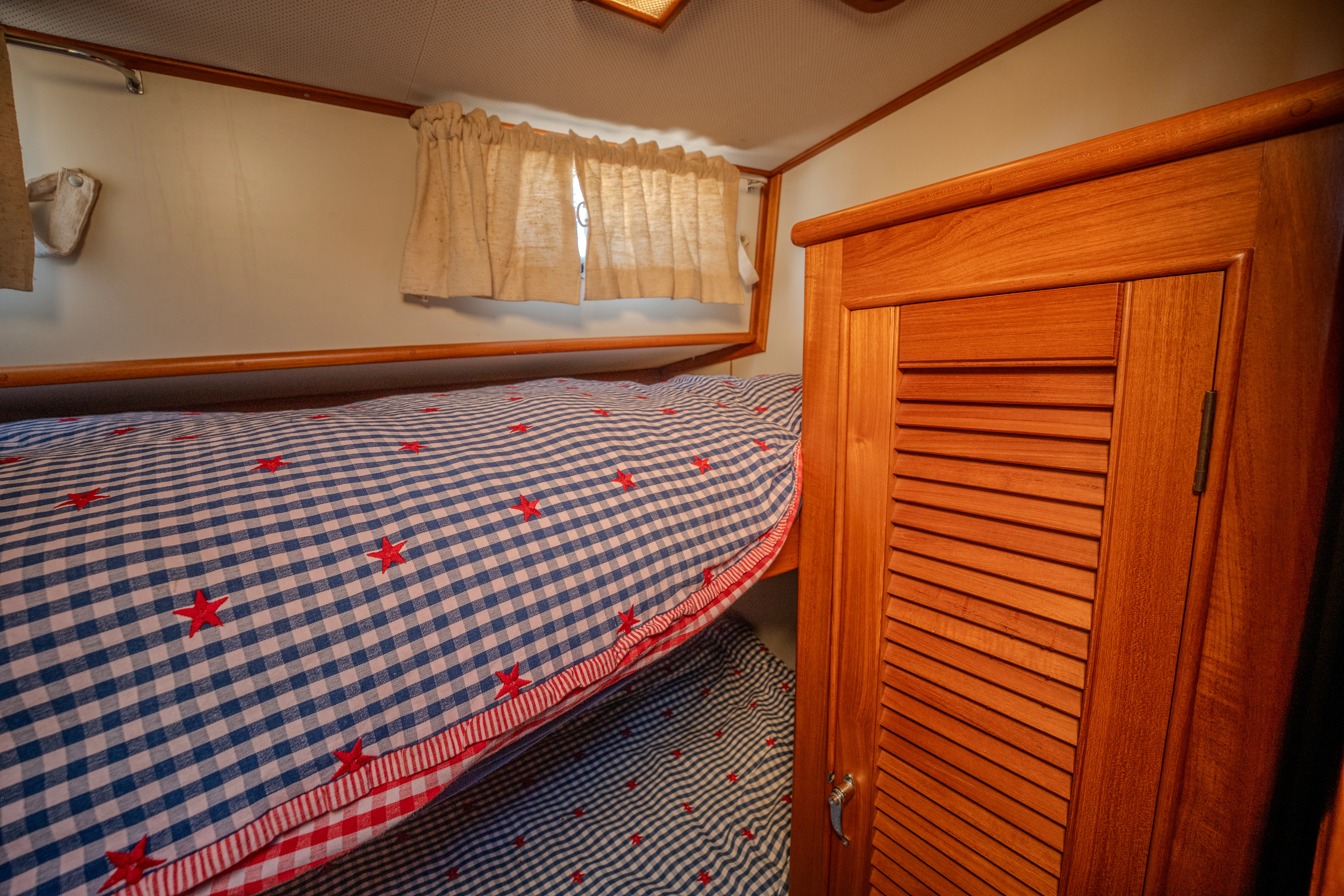 a room with a bed and a closet aboard OSPREY Yacht for Sale