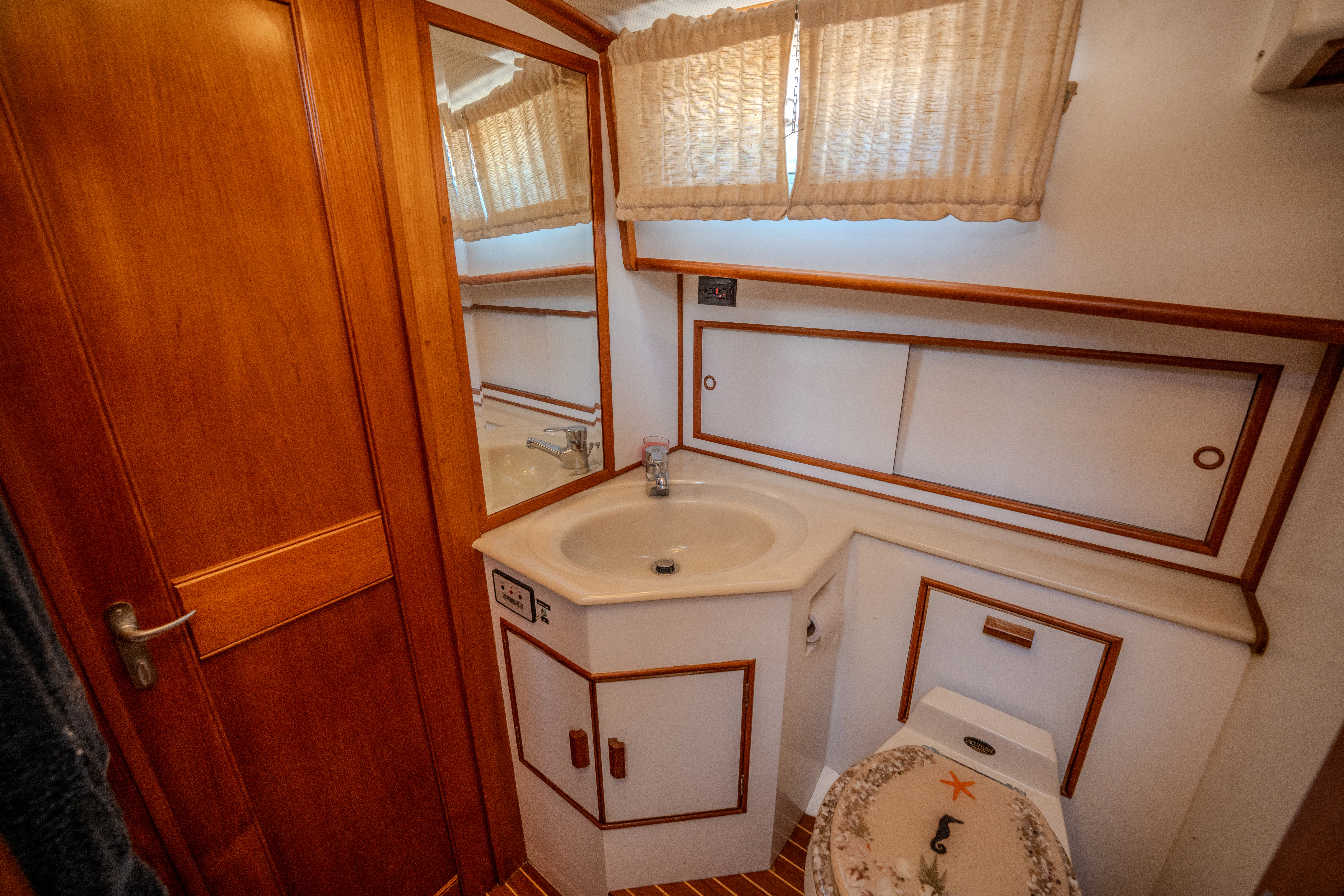 a bathroom with a sink and cabinets aboard OSPREY Yacht for Sale