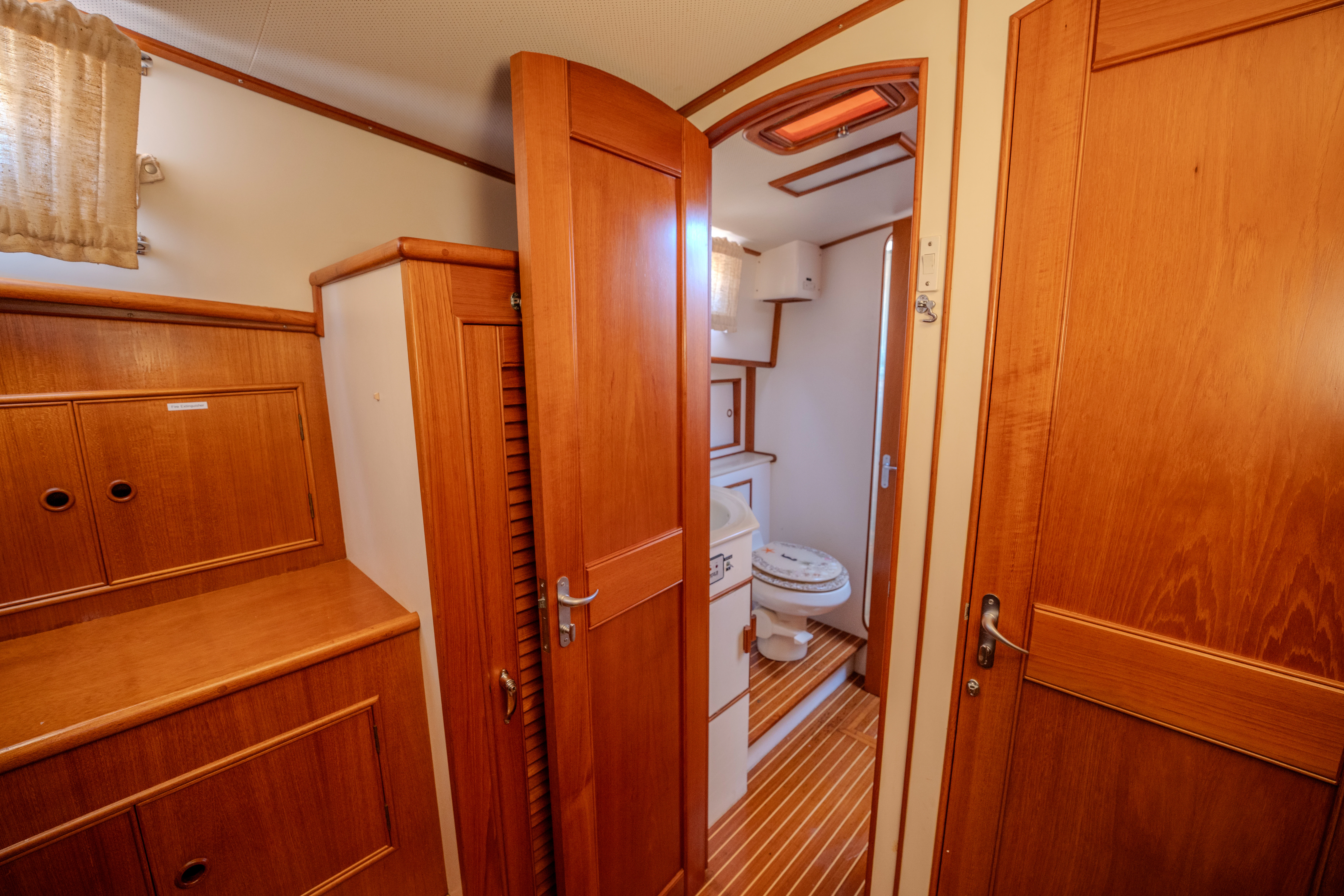 a bathroom with wooden cabinets aboard OSPREY Yacht for Sale