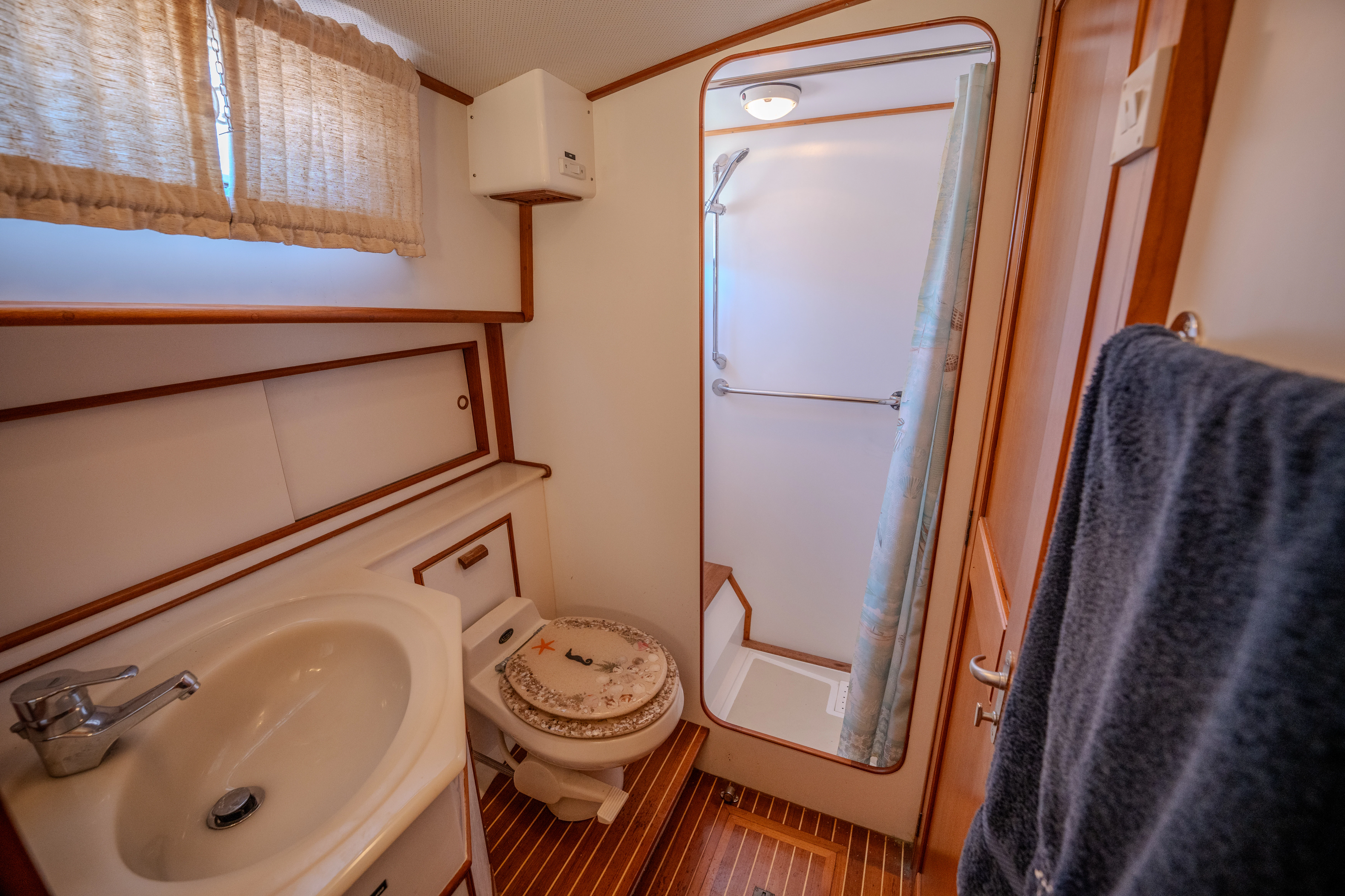 a bathroom with a toilet and sink aboard OSPREY Yacht for Sale