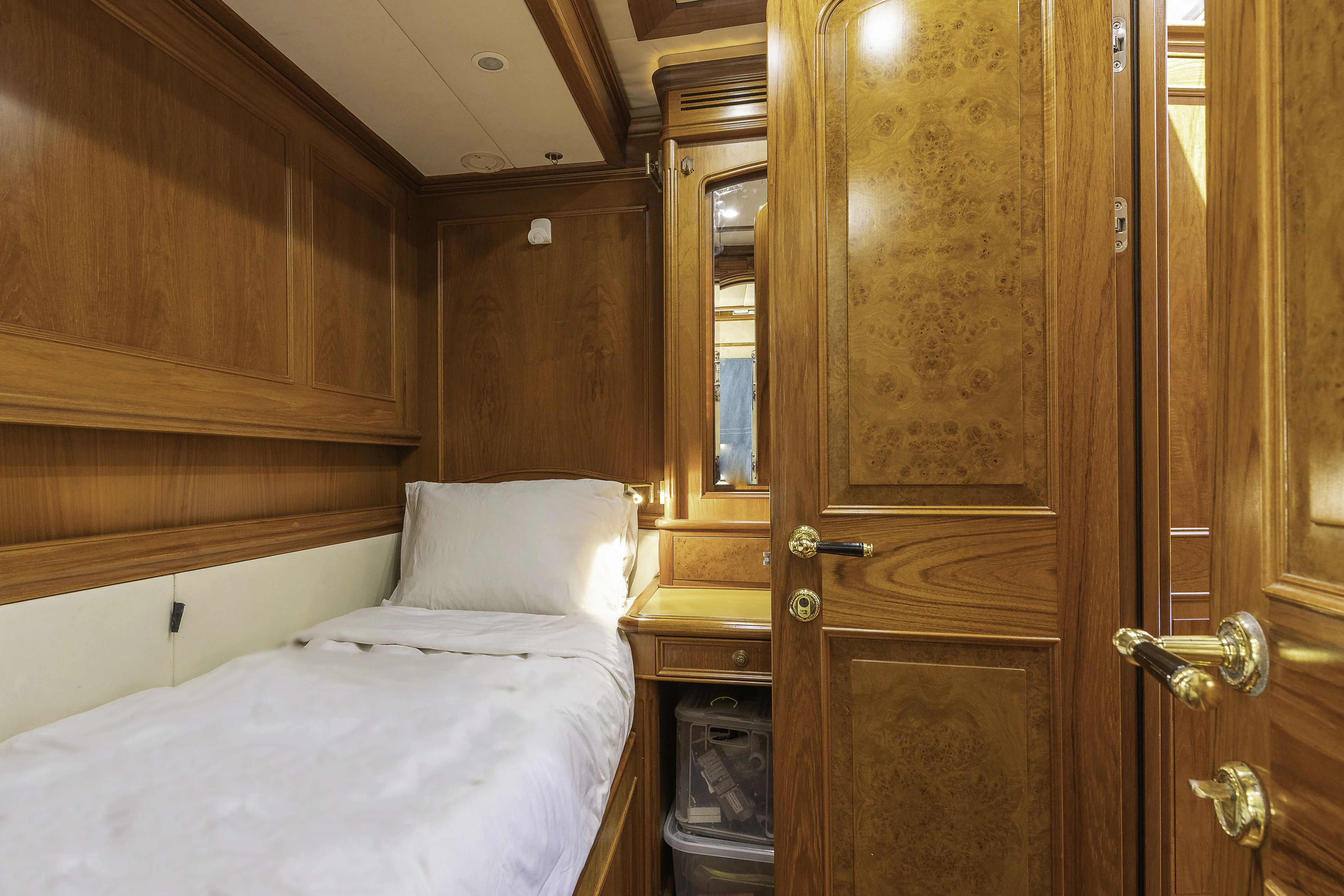 a bedroom with a bed and a closet aboard SONG OF THE SEA Yacht for Sale